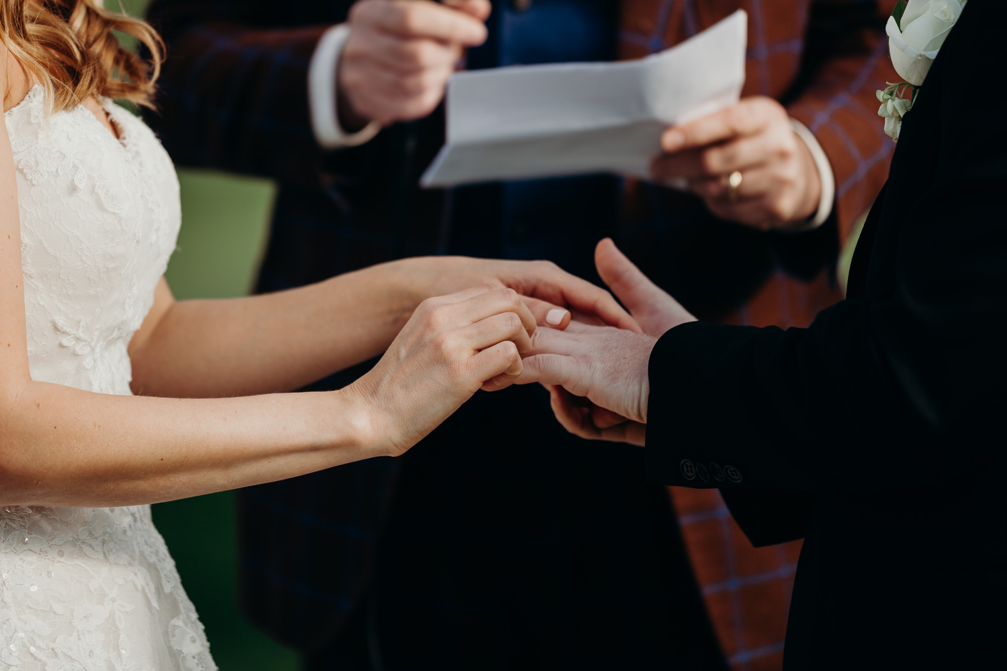 ring exchange during a wedding ceremony at the upper montclair country club in montclair, new jersey