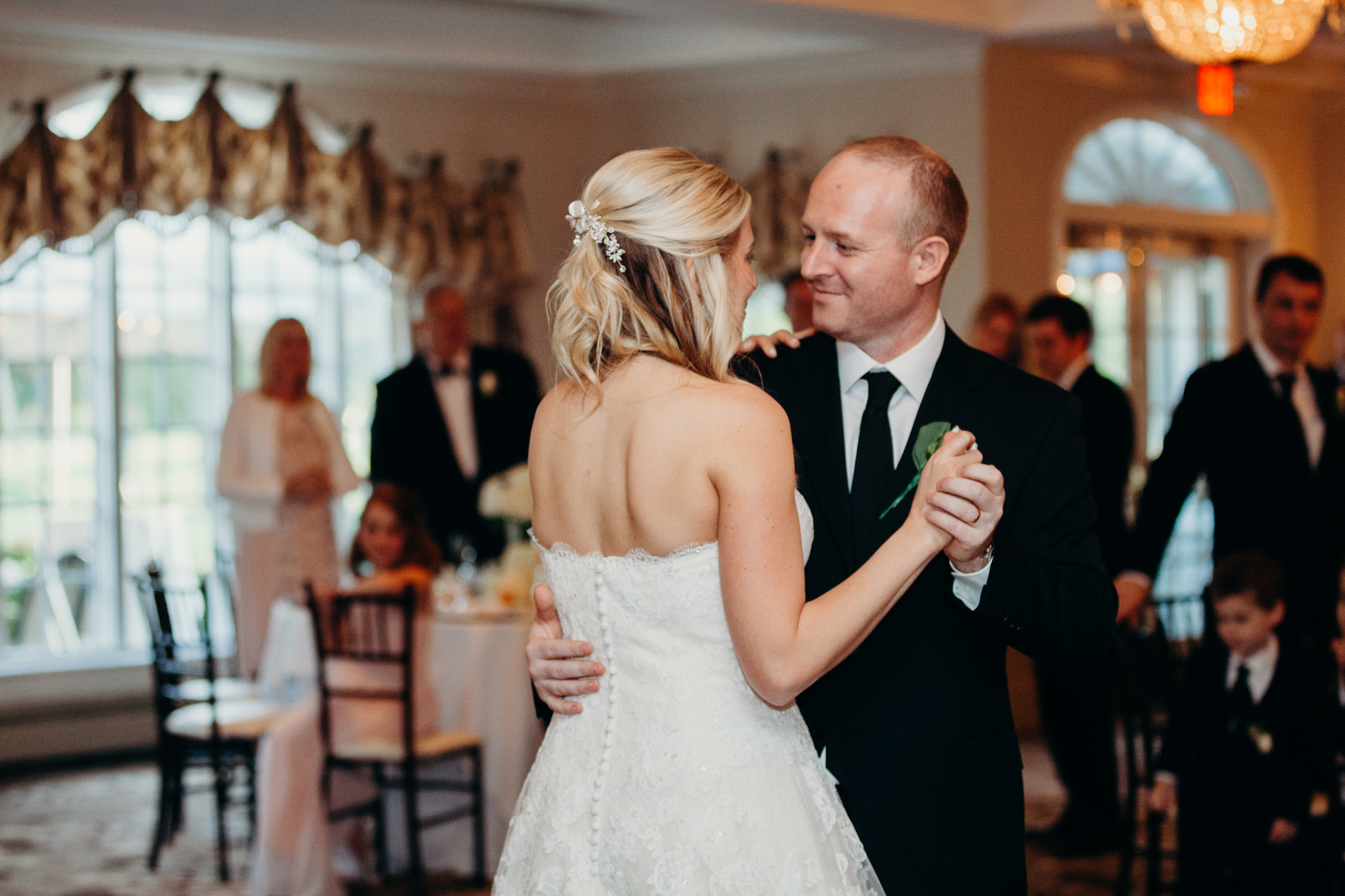 a bride and groom share a first dance at the upper montclair country club in montclair, new jersey