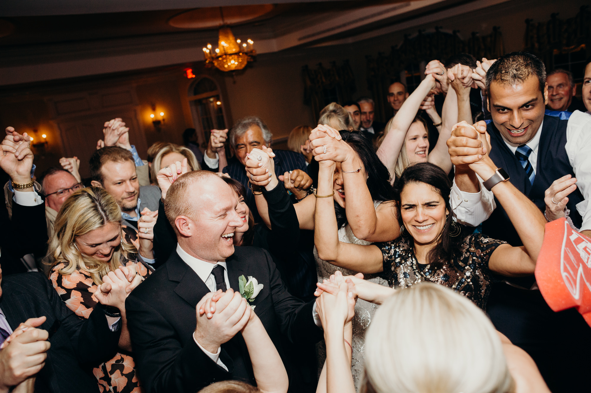 wedding guests dance at the reception at the upper montclair country club in montclair, new jersey