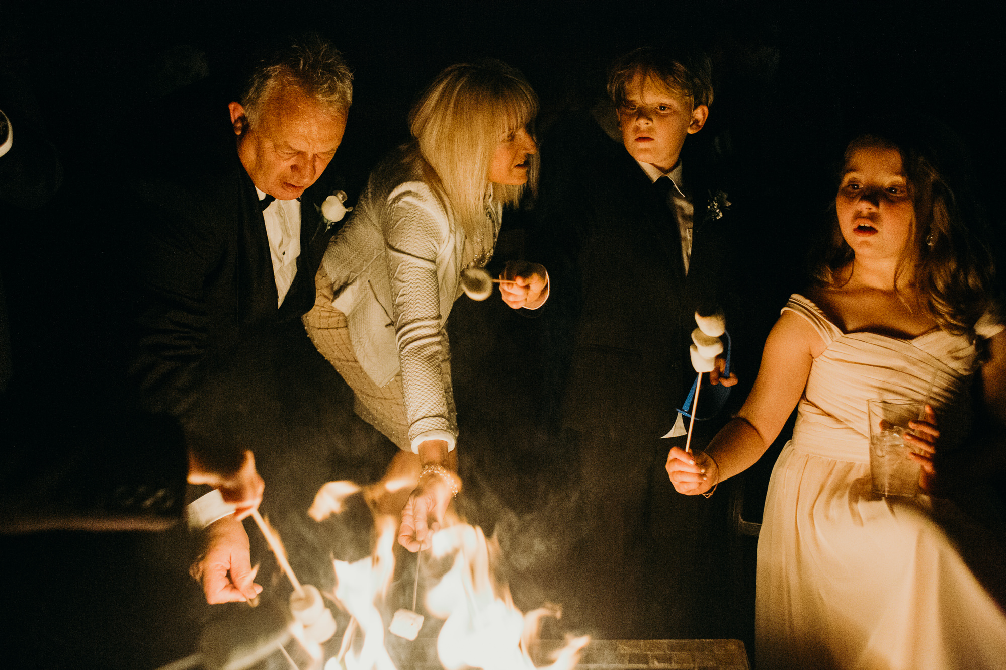 wedding guests at a firepit at the upper montclair country club in montclair, new jersey