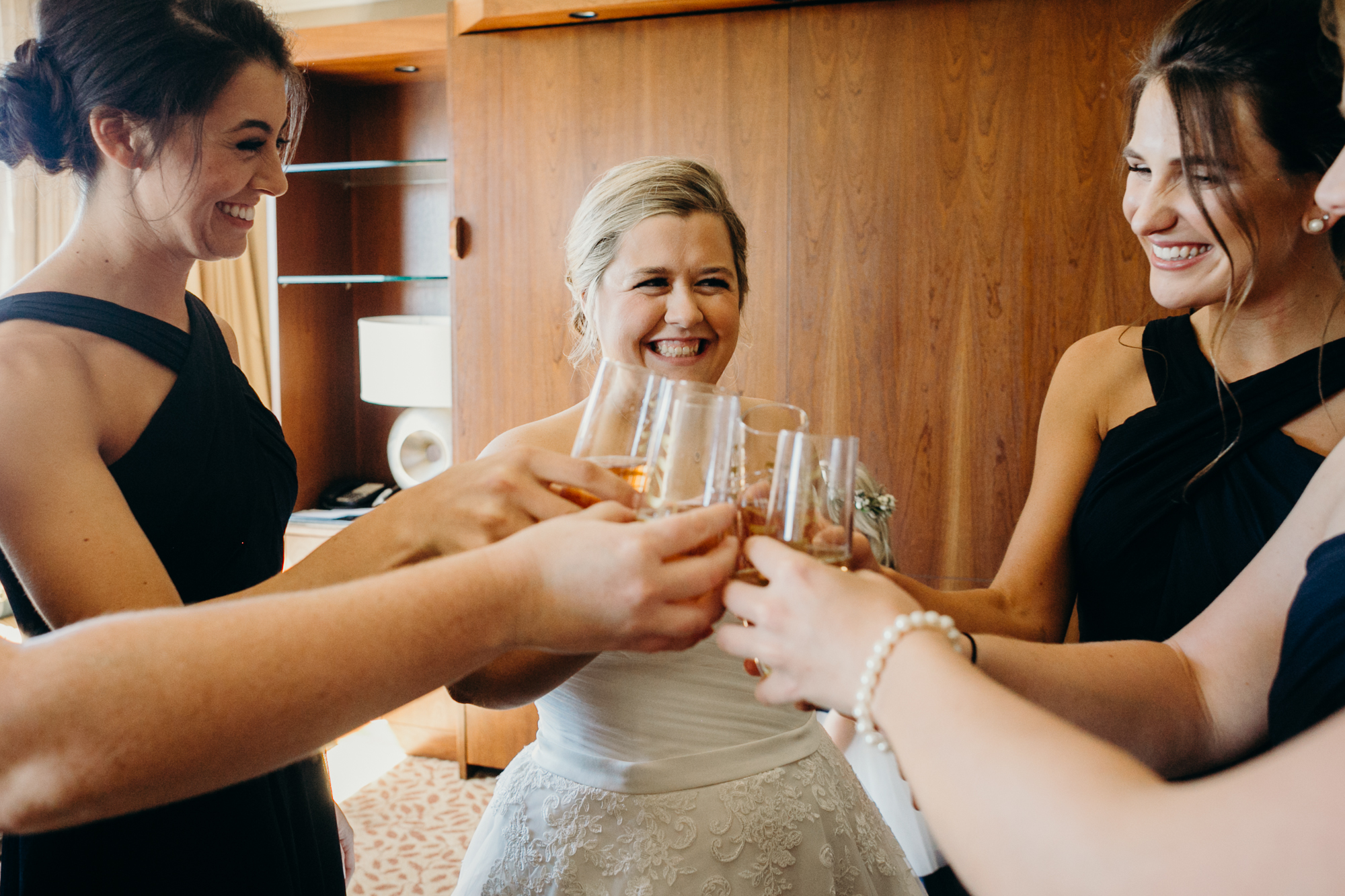 bride and bridesmaids cheers-ing at country club of darien in darien, connecticut