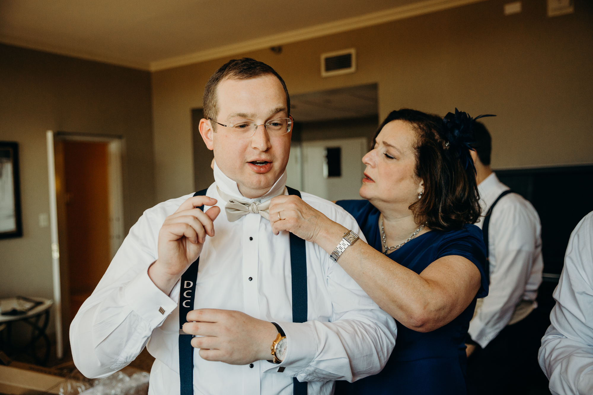 groom getting ready with his mom at country club of darien in darien, connecticut