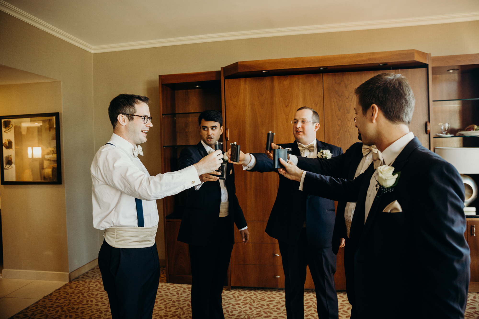 groom and groomsmen cheers-ing at country club of darien in darien, connecticut