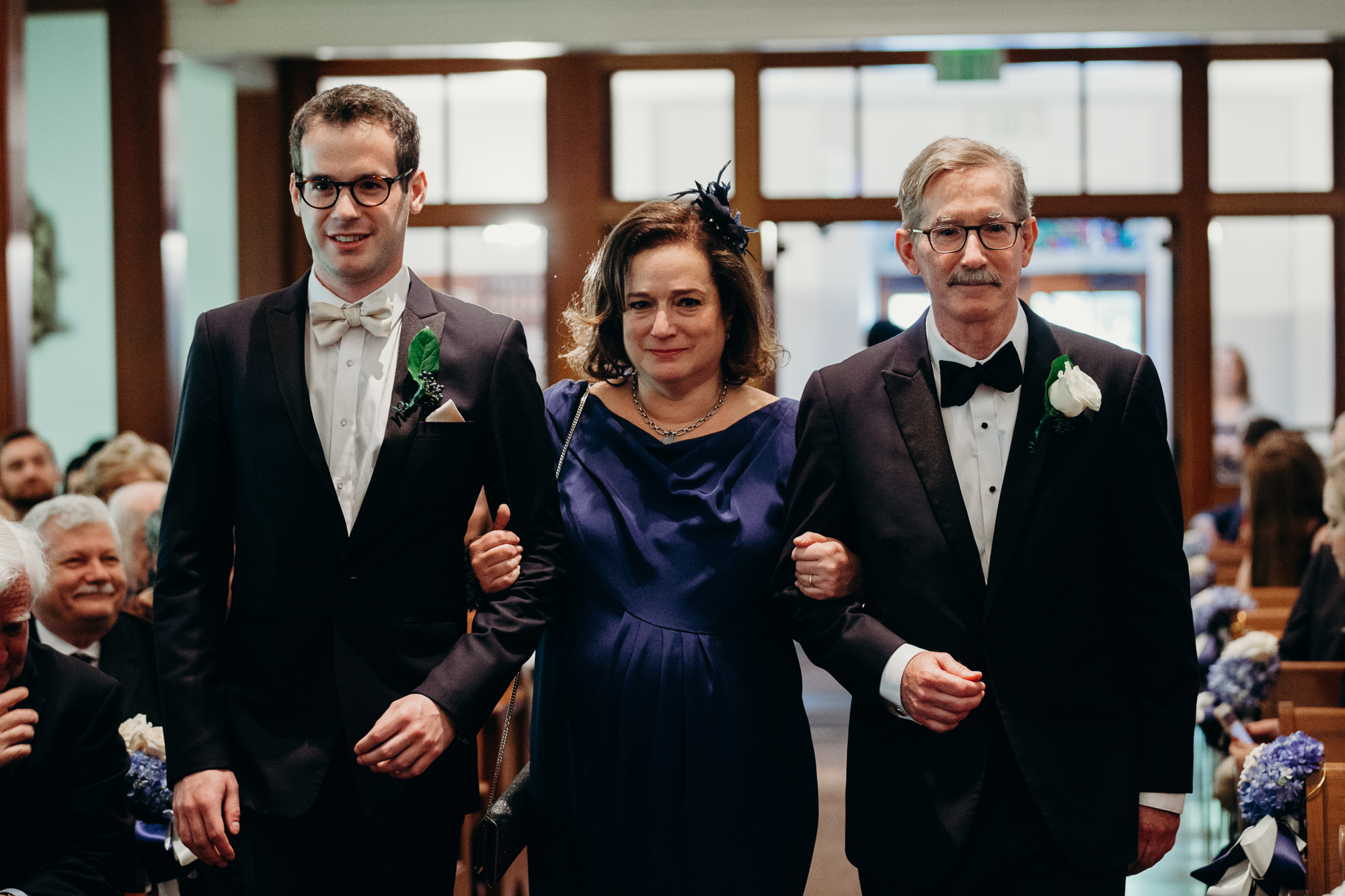 parents walking down the aisle during a wedding ceremony at country club of darien in darien, connecticut