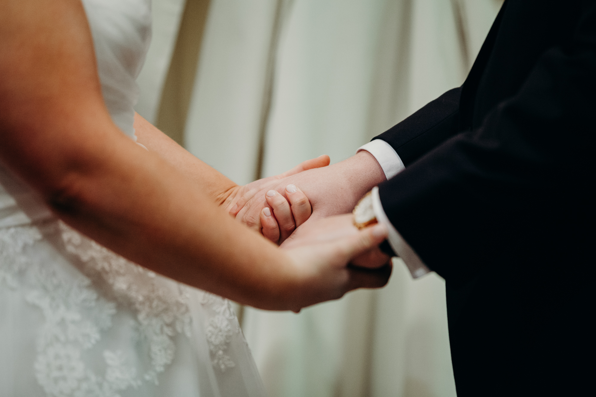 bride and groom holding hands during their wedding ceremony at country club of darien in darien, connecticut