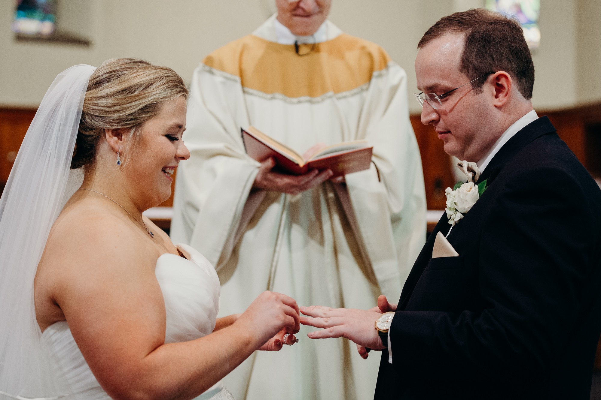 bride and groom exchange rings at their wedding ceremony at country club of darien in darien, connecticut