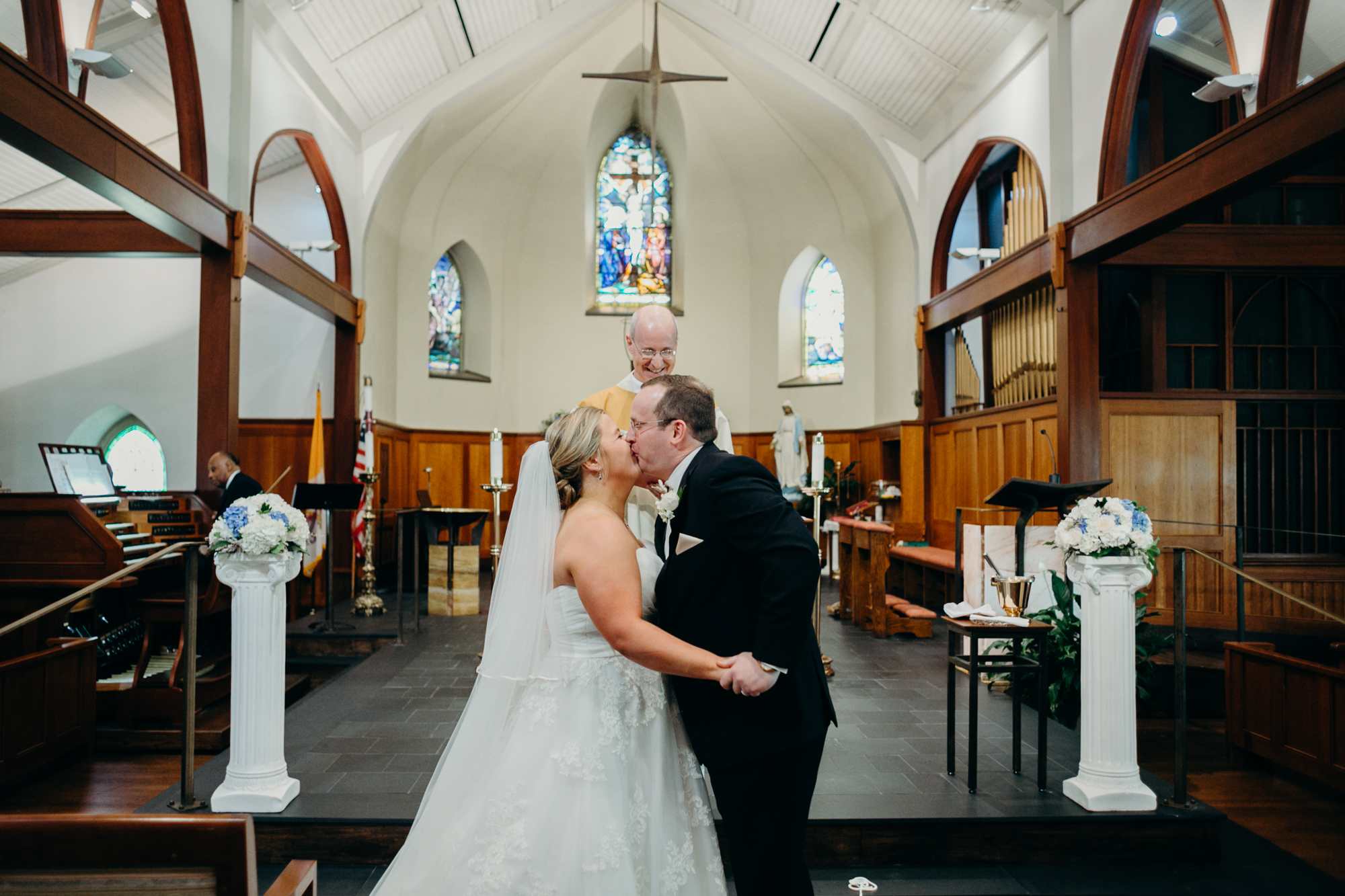 bride and groom kiss during their wedding ceremony at country club of darien in darien, connecticut