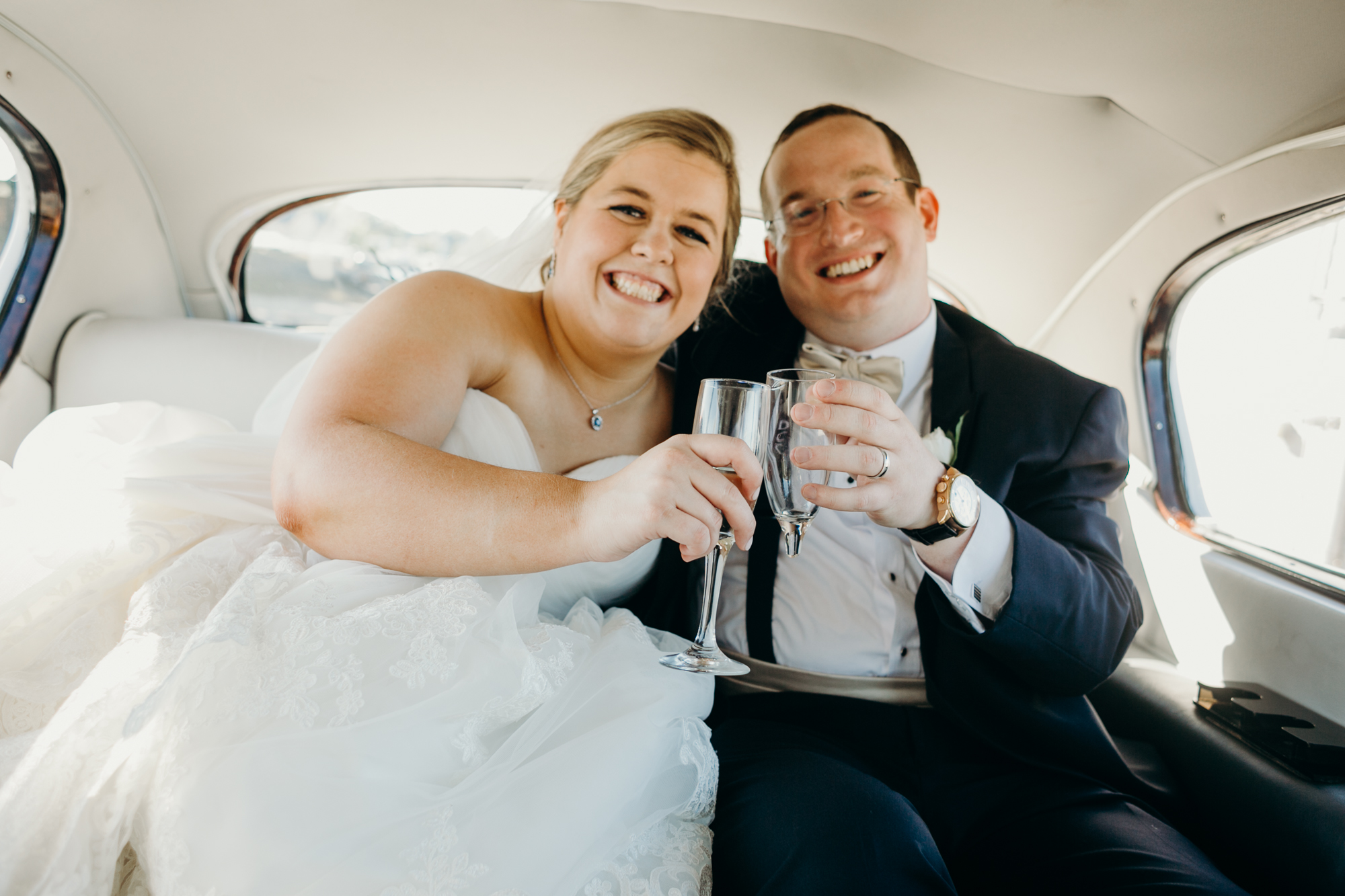 portrait of a bride and groom in a classic rolls royce at country club of darien in darien, connecticut