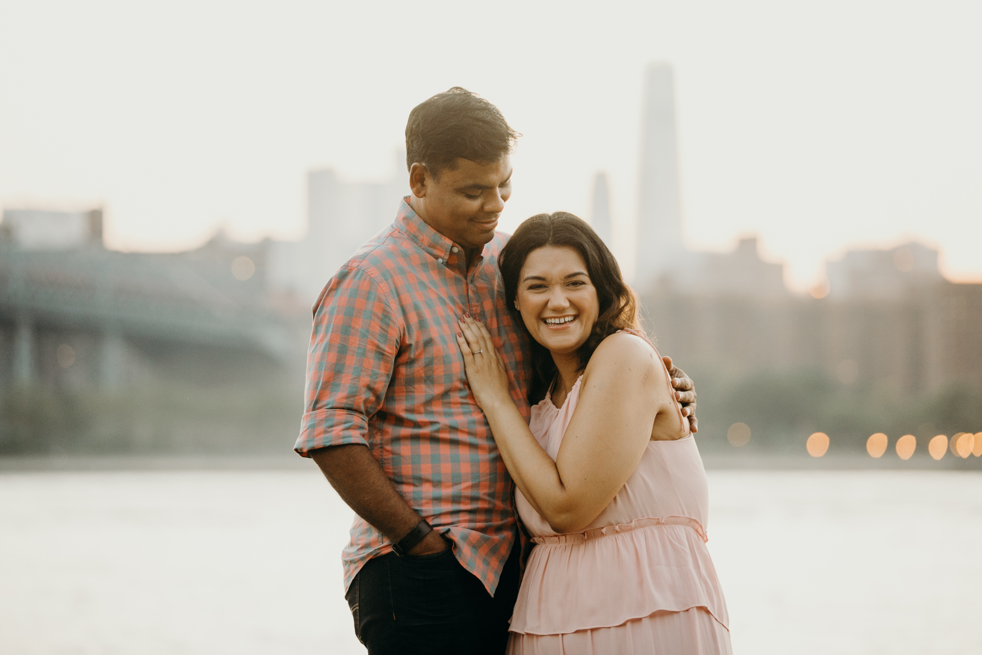 a portrait of a couple on the waterfront facing manhattan in williamsburg, brooklyn
