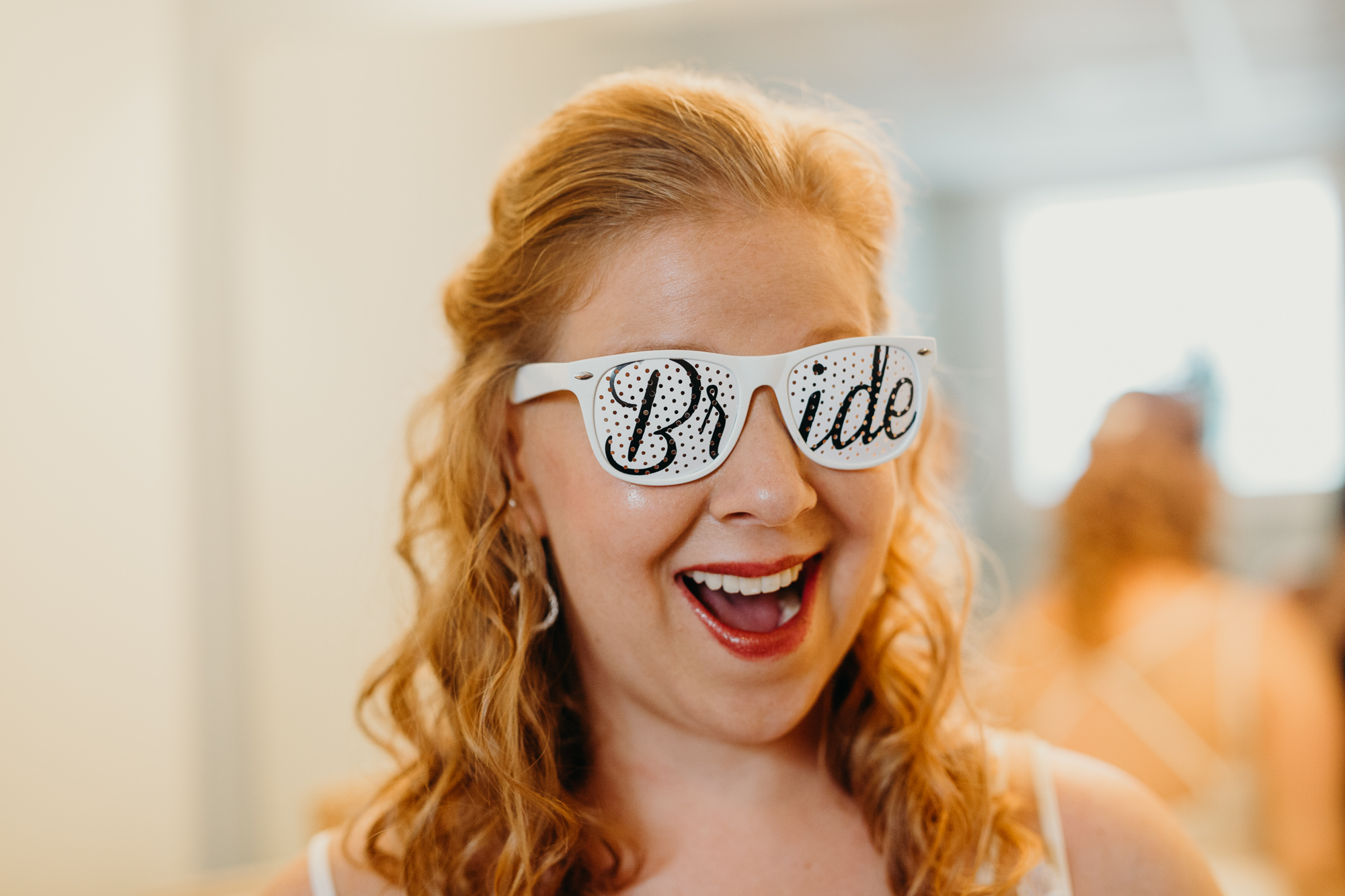 portrait of a bride wearing sunglasses at hayloft on the arch in syracuse, new york