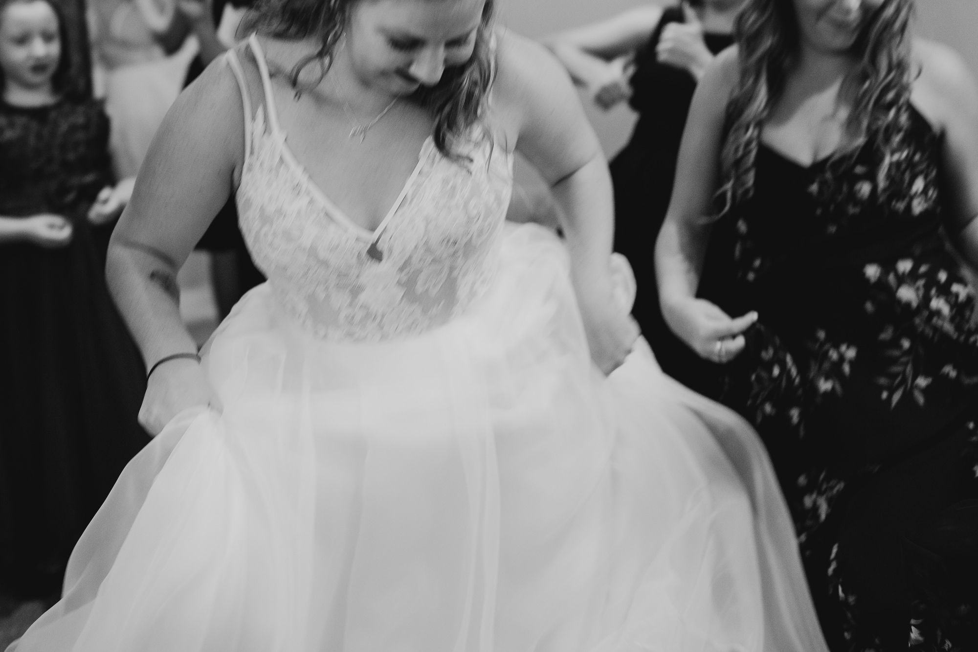 bride dancing with her maid of honor before her wedding at hayloft on the arch in syracuse, ny