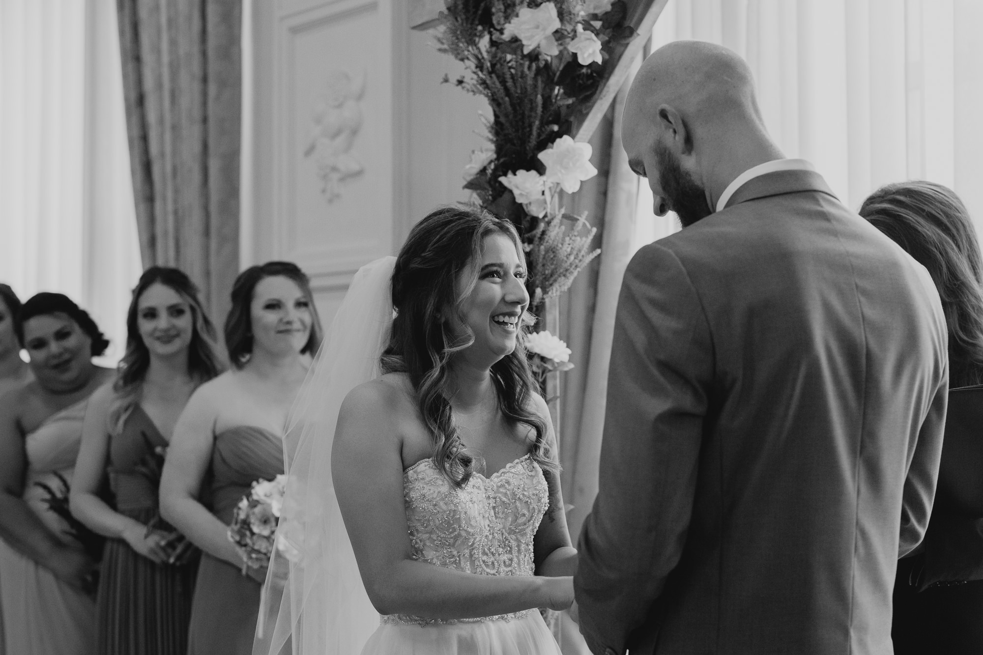 a bride laughs during her wedding ceremony at the lafayette hotel in buffalo, ny
