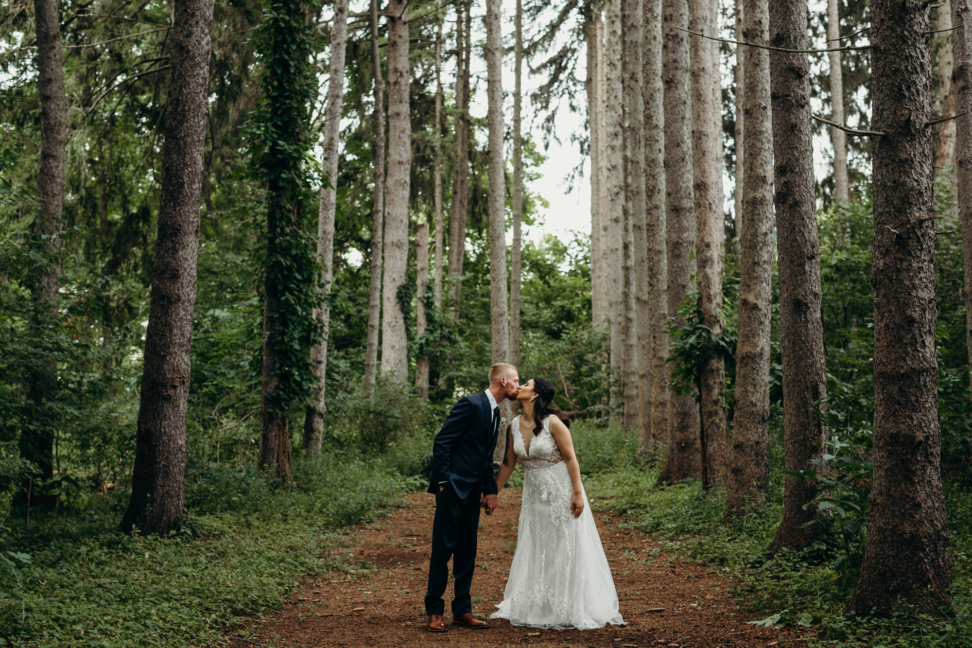 a wedding portrait of a bride and groom in a forest at dibbles inn in syracuse, ny