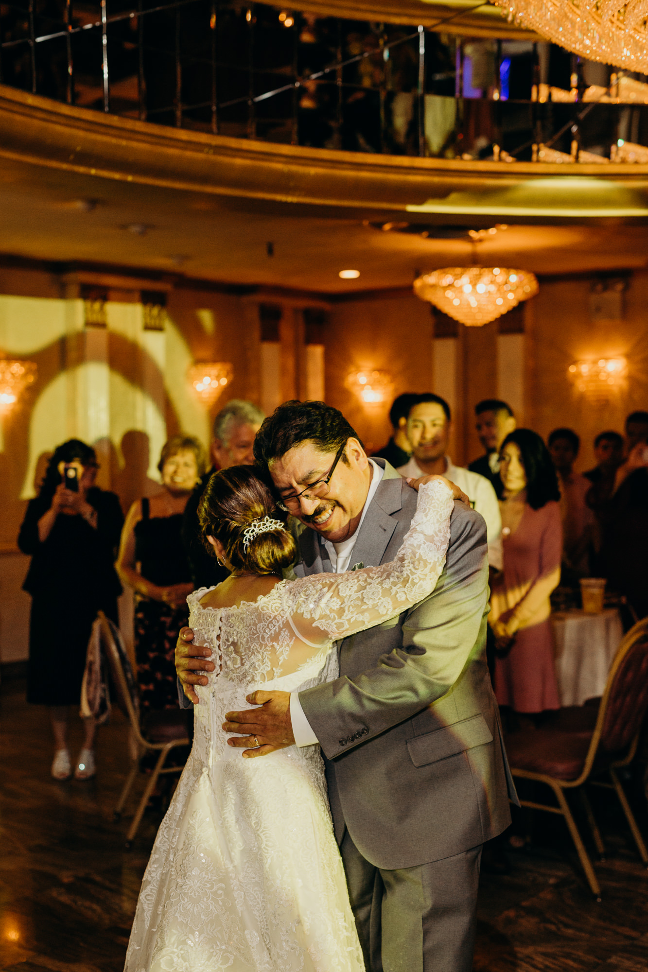a bride and groom dance together during their wedding reception in queens, ny