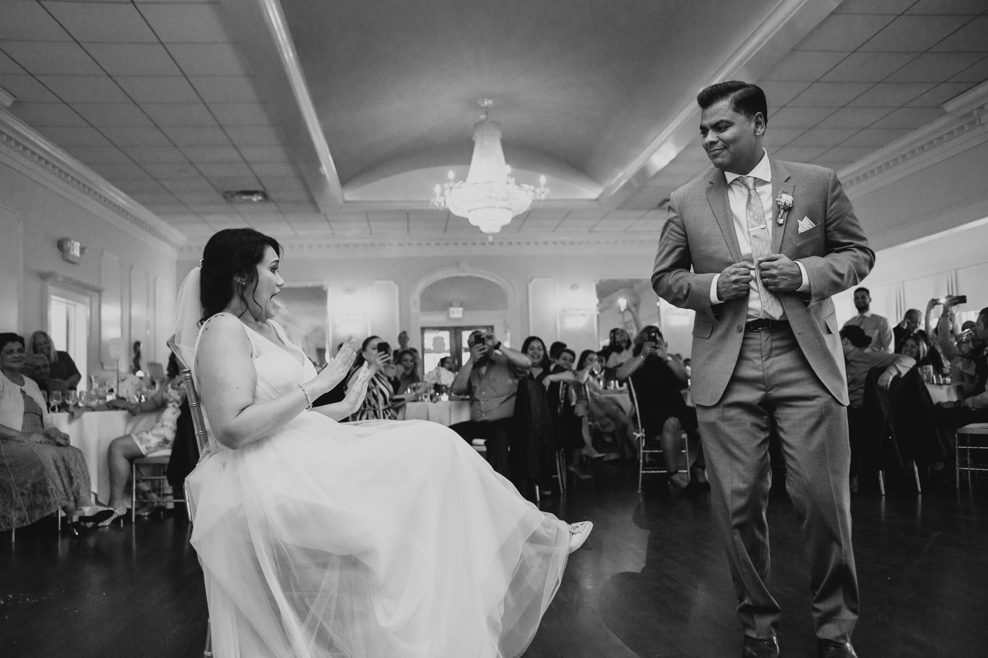 a bride and groom dance together during their wedding reception at a country club in long island, ny