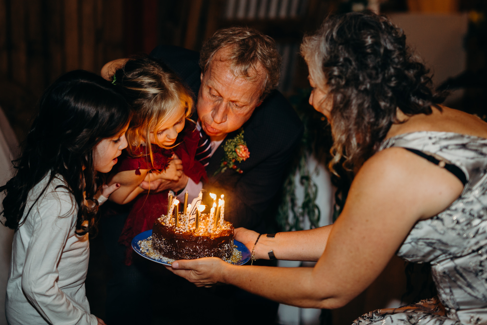 a flower girl blows out her birthday candles at hayloft on the arch in syracuse, ny