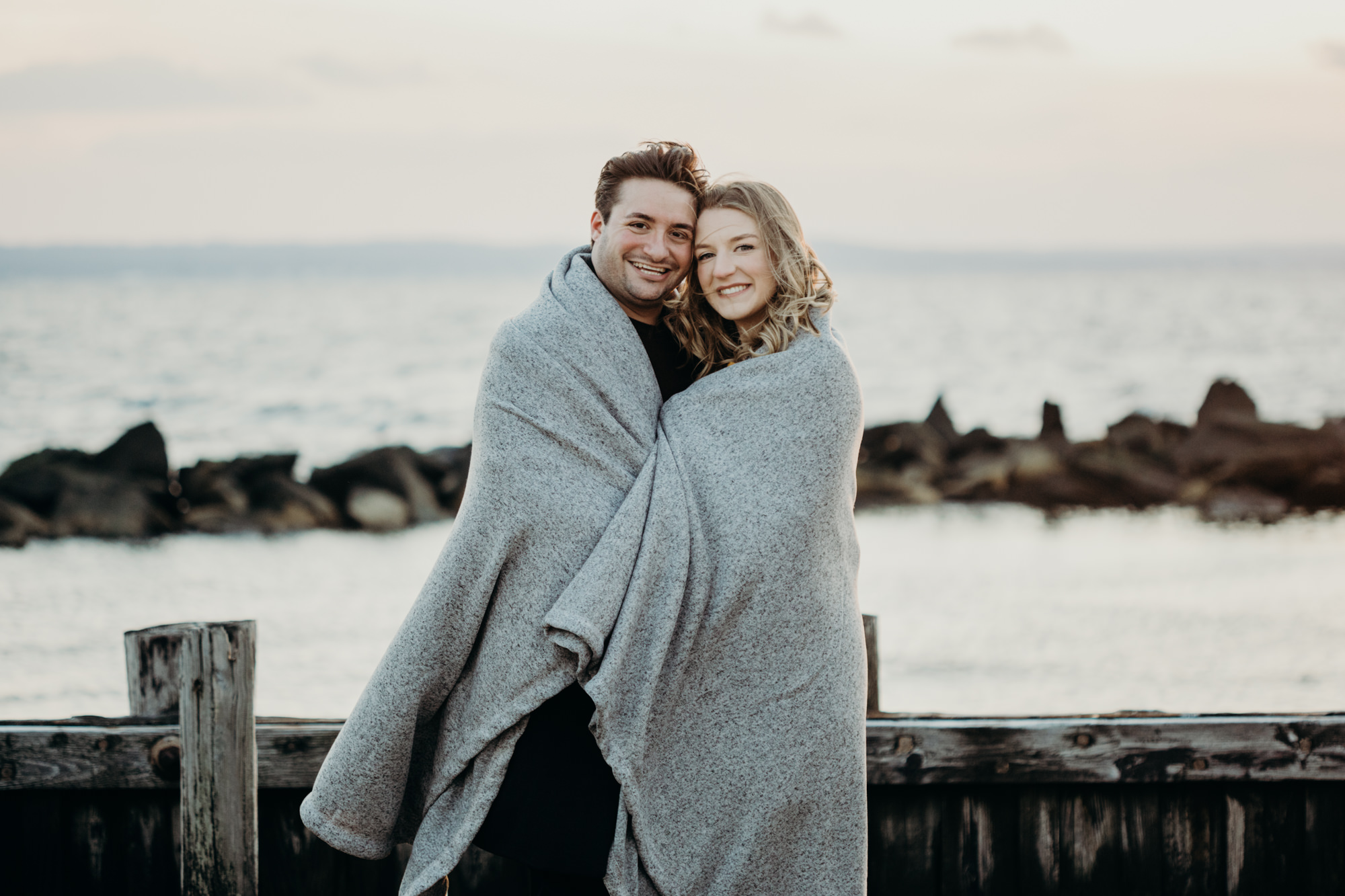 portrait of a couple in a blanket at sandy hook in sandy hook, NJ