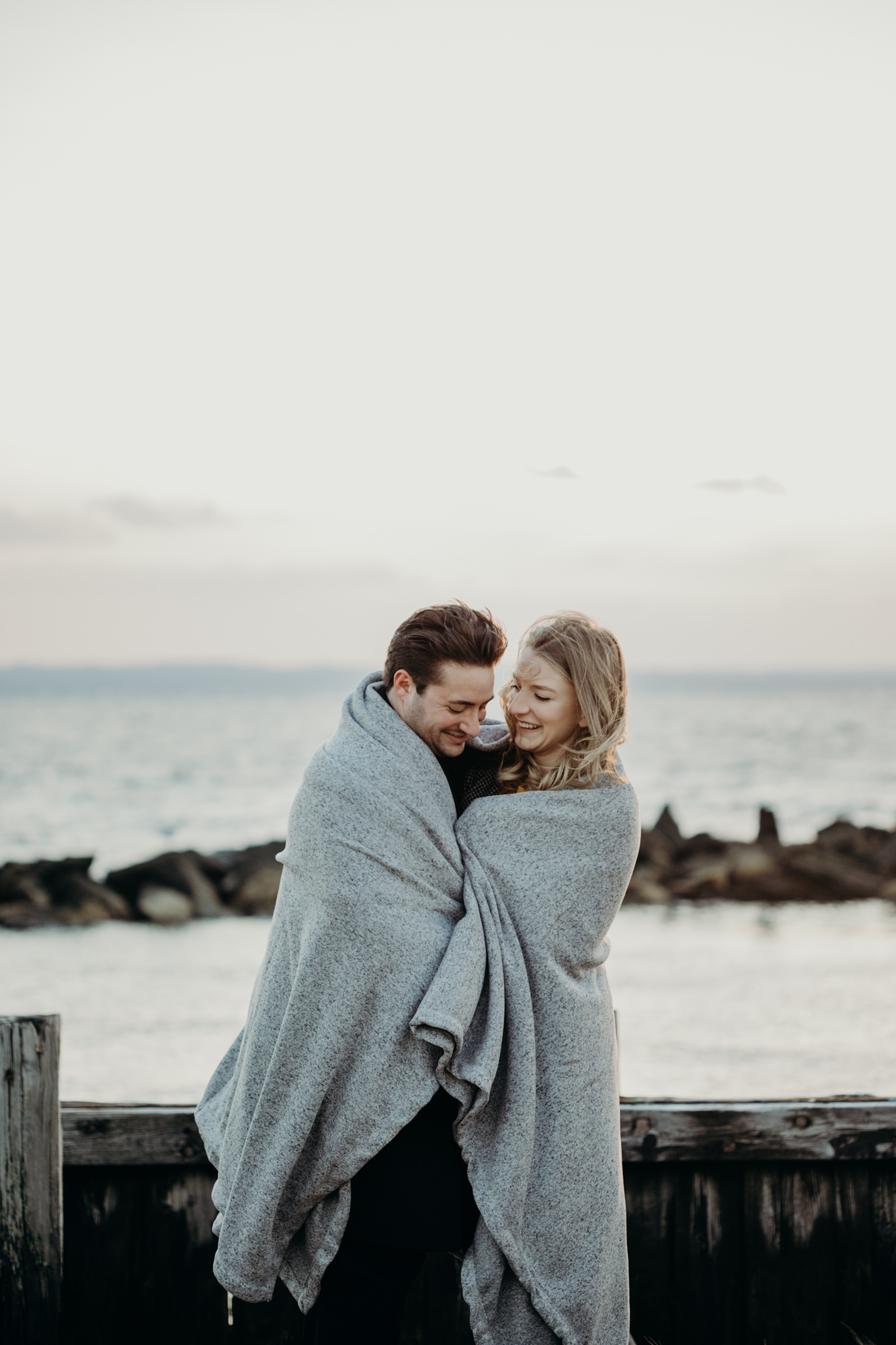 portrait of a couple in a blanket at sandy hook in sandy hook, NJ