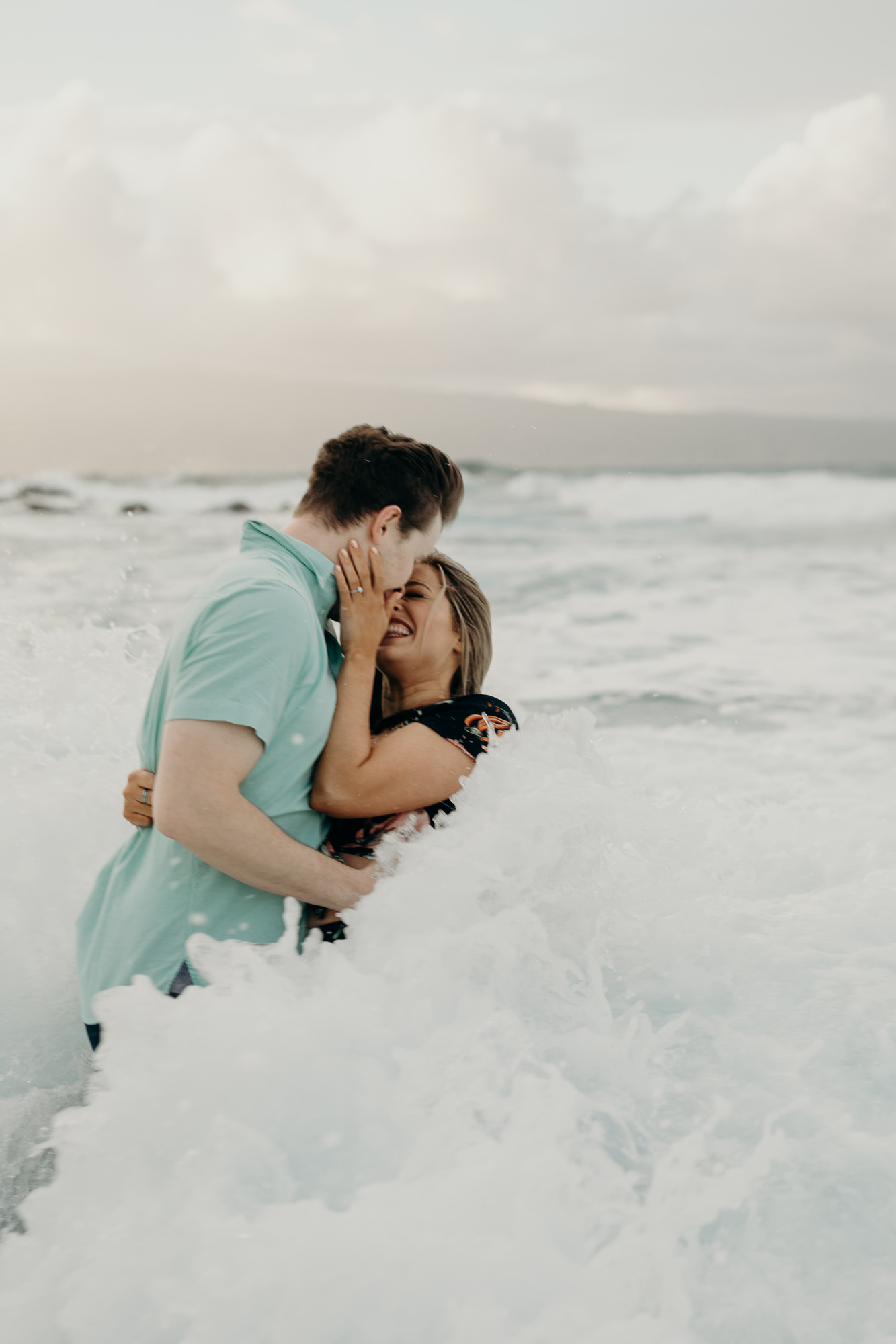 portrait of a couple kissing in the ocean in maui, HI