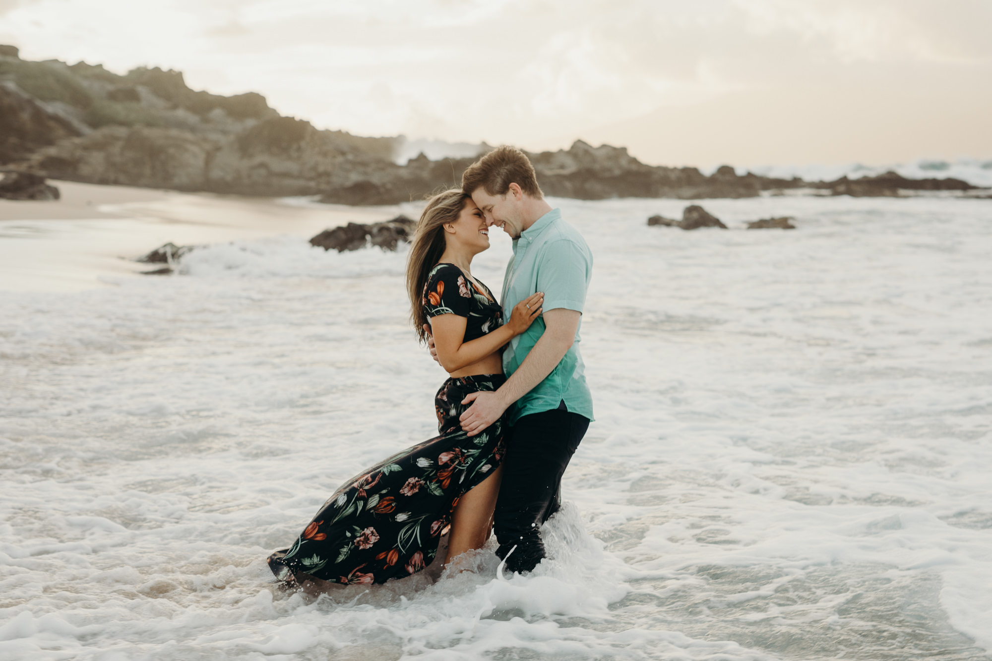 portrait of a couple in the ocean in maui, HI