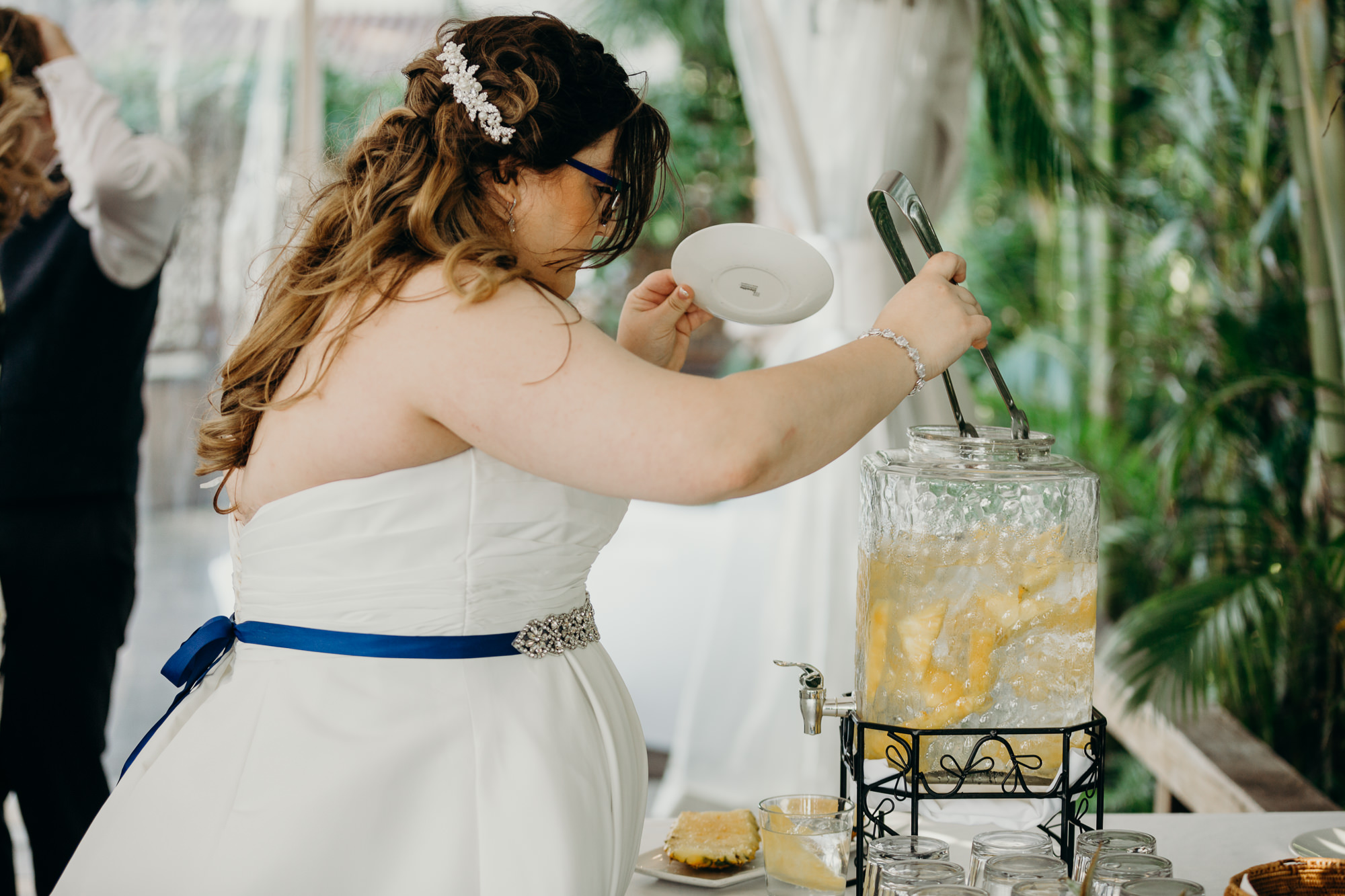 bride looks for a pineapple at merrimans' maui in kaanapali, HI