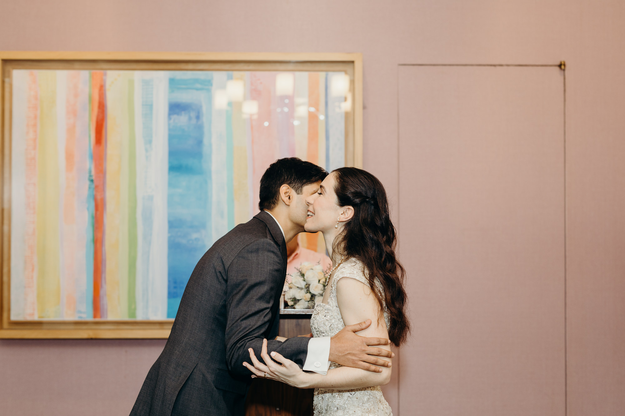 bride and groom kiss during their wedding ceremony at city hall in new york city, ny