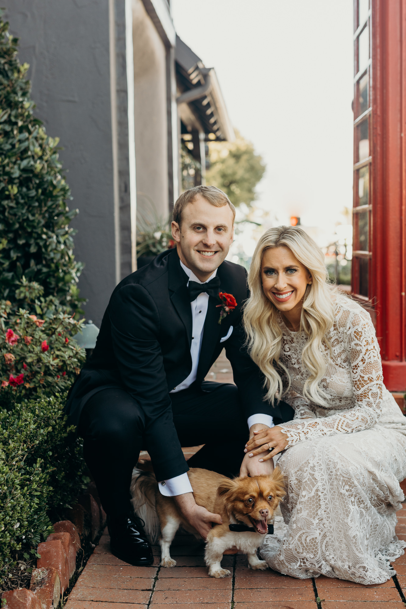 bride and groom with dog portrait outside five crowns in newport CA