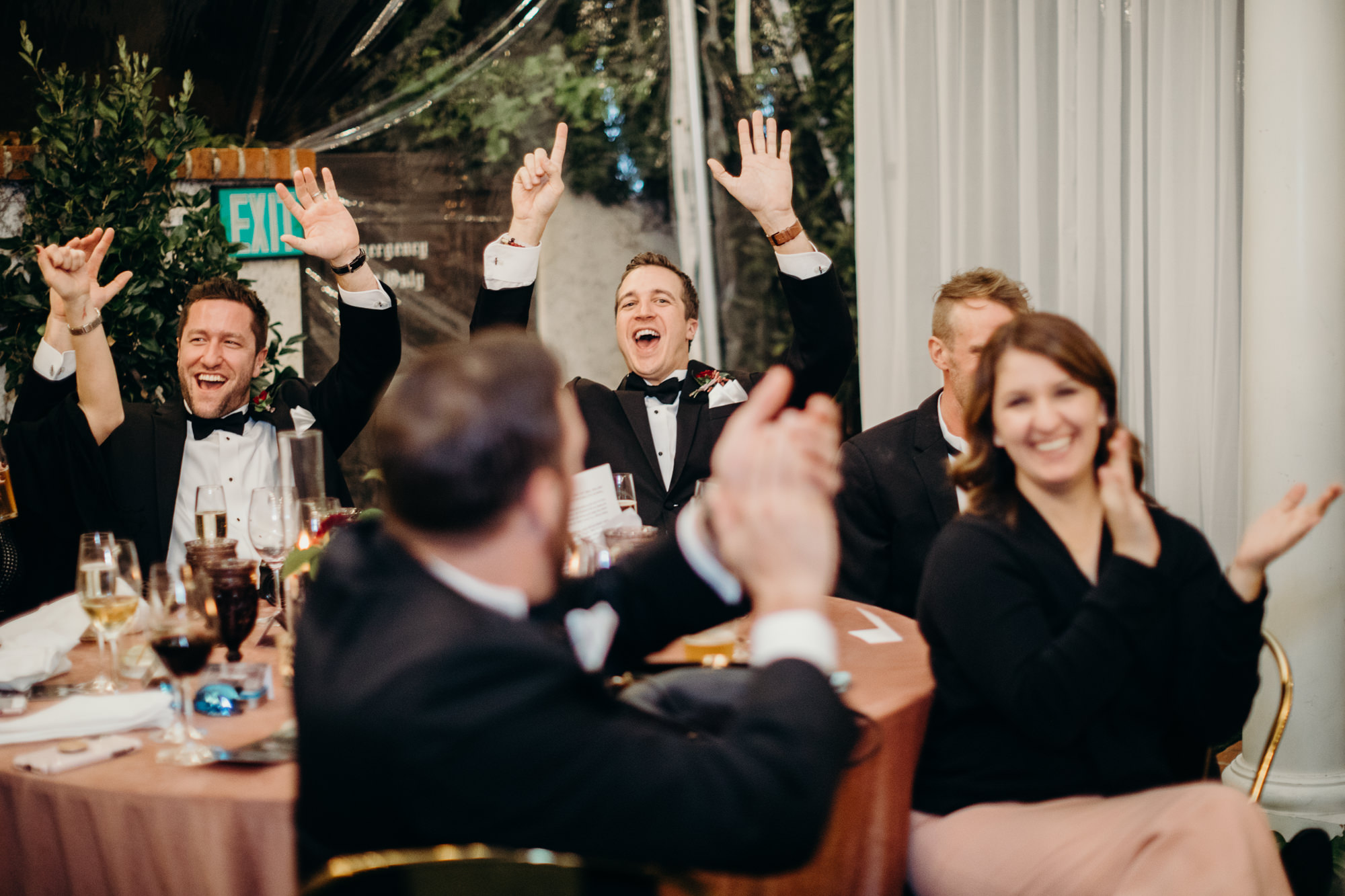 guests cheer during wedding speeches at five crowns in newport beach, CA