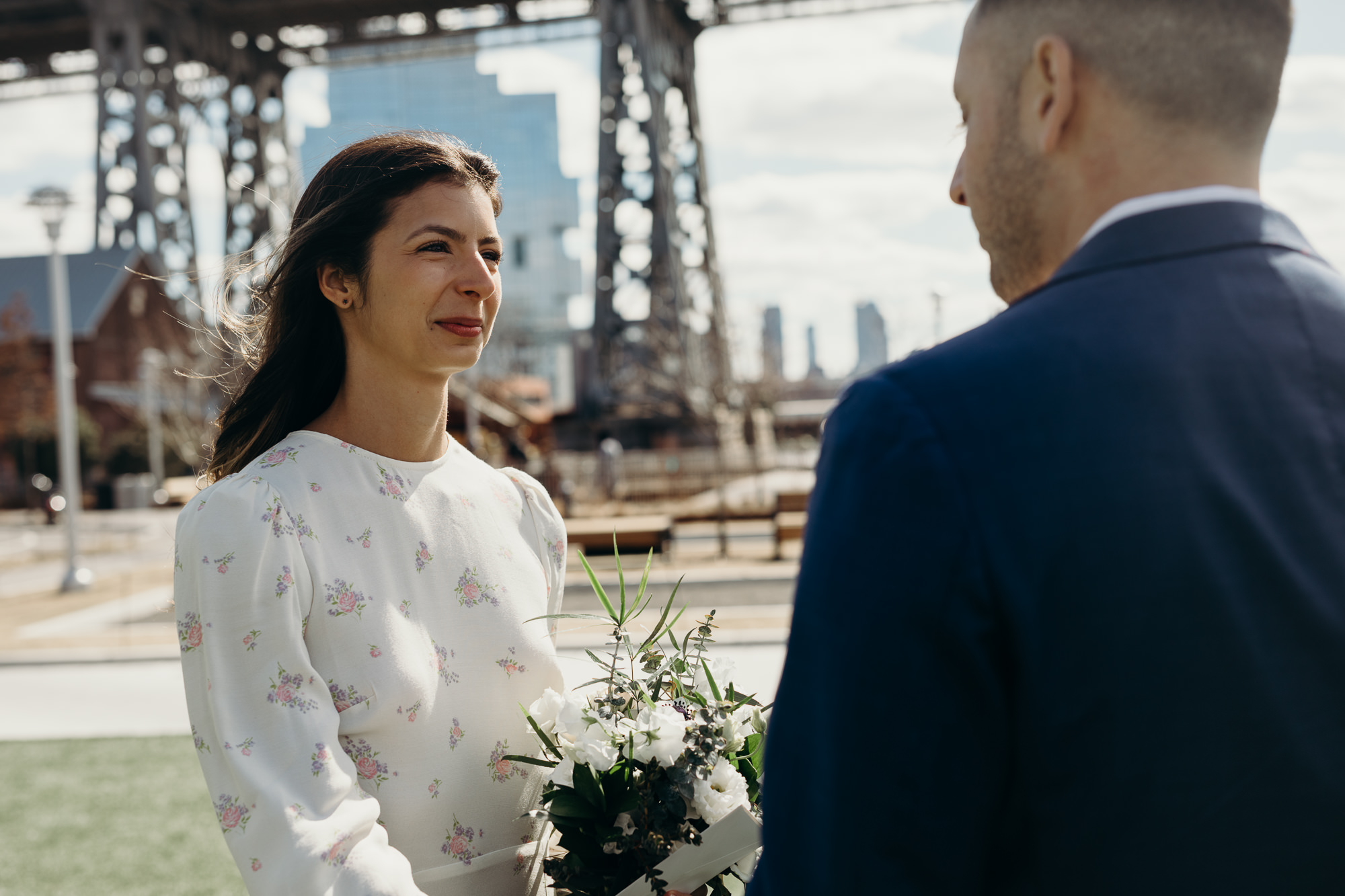 bride and groom during their wedding ceremony at domino park in brooklyn, ny