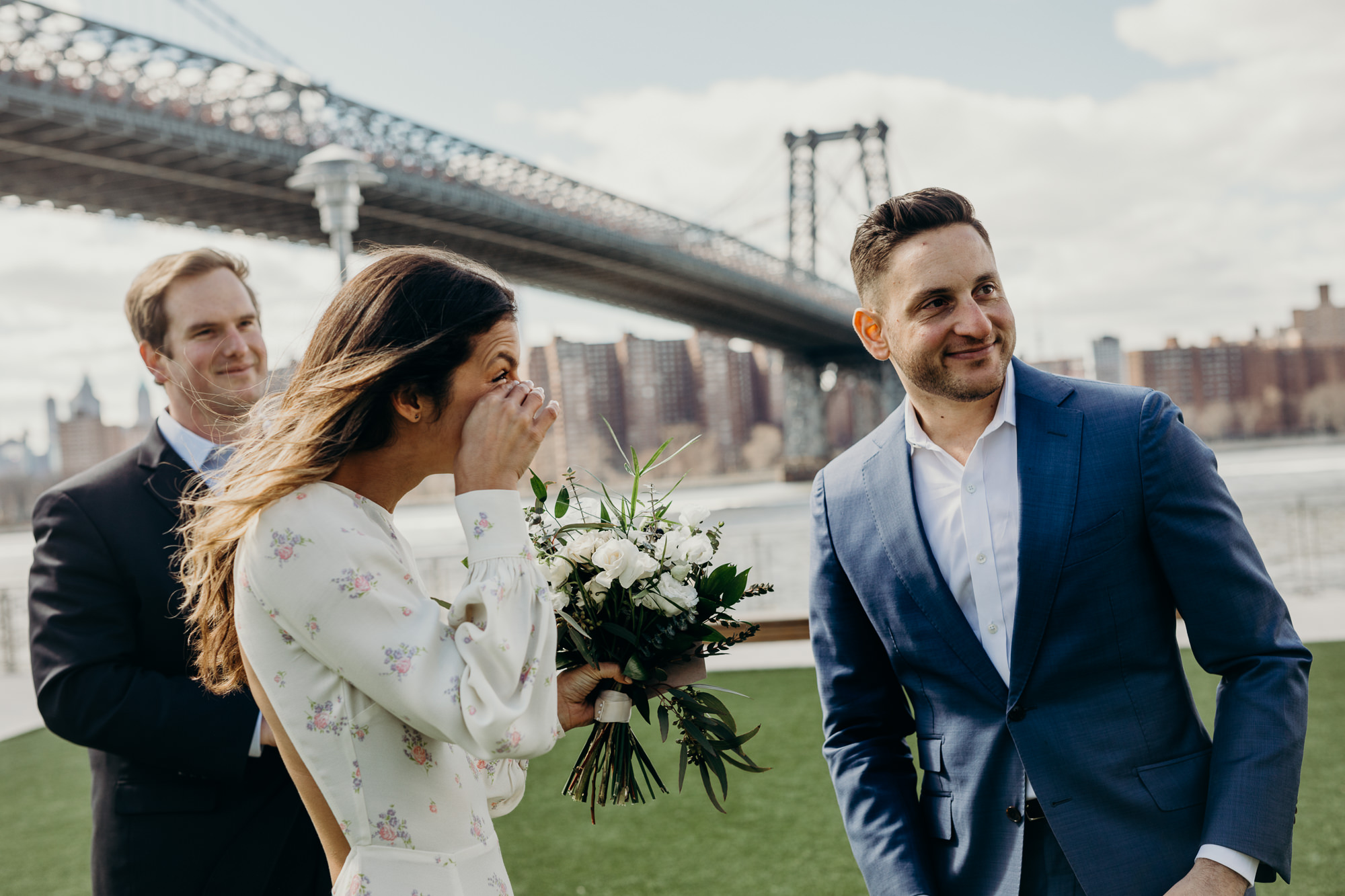 a bride and groom after their wedding ceremony at domino park in brooklyn, new york