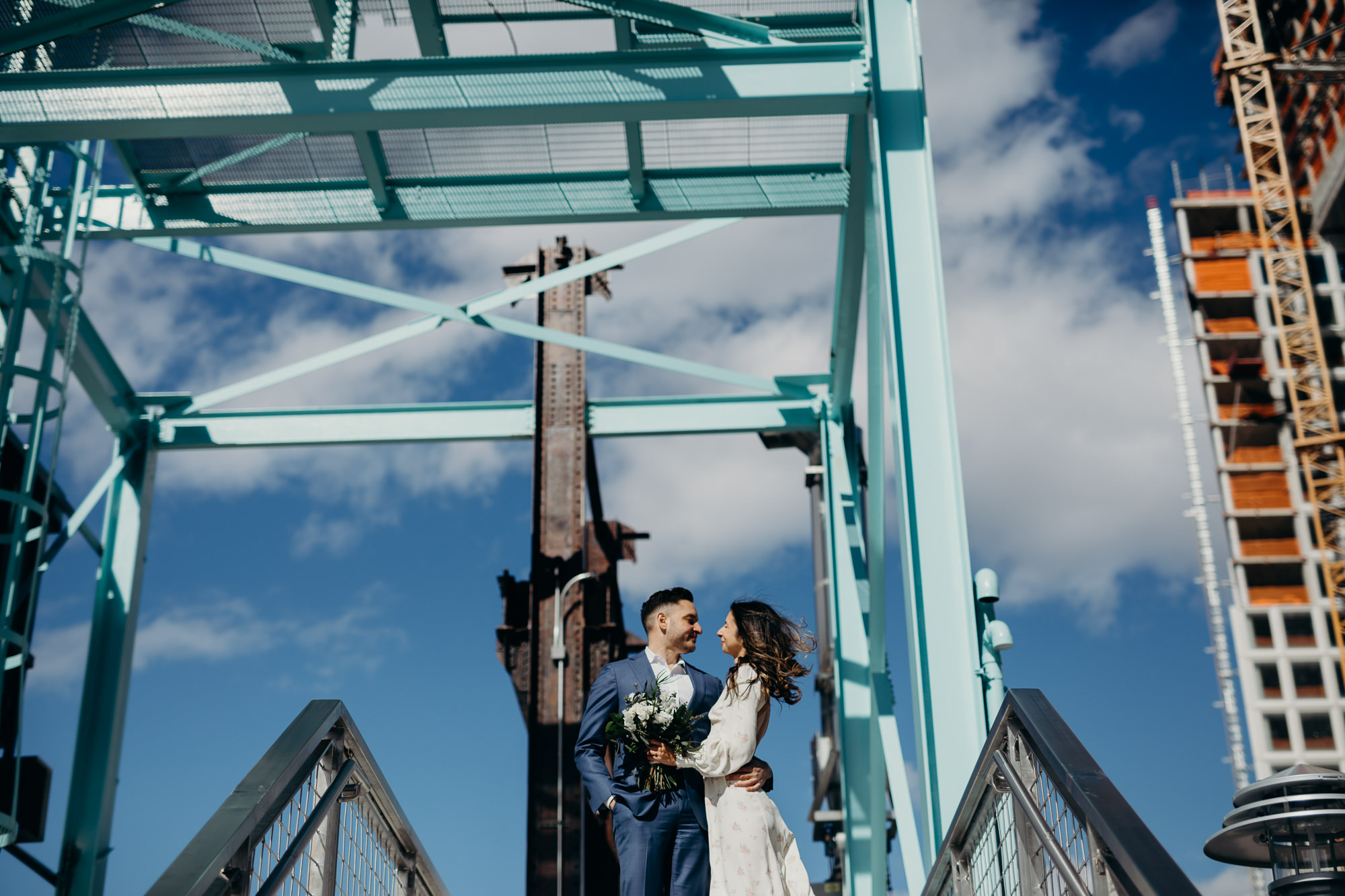 portrait of a bride and groom on their wedding day at domino park in brooklyn, ny