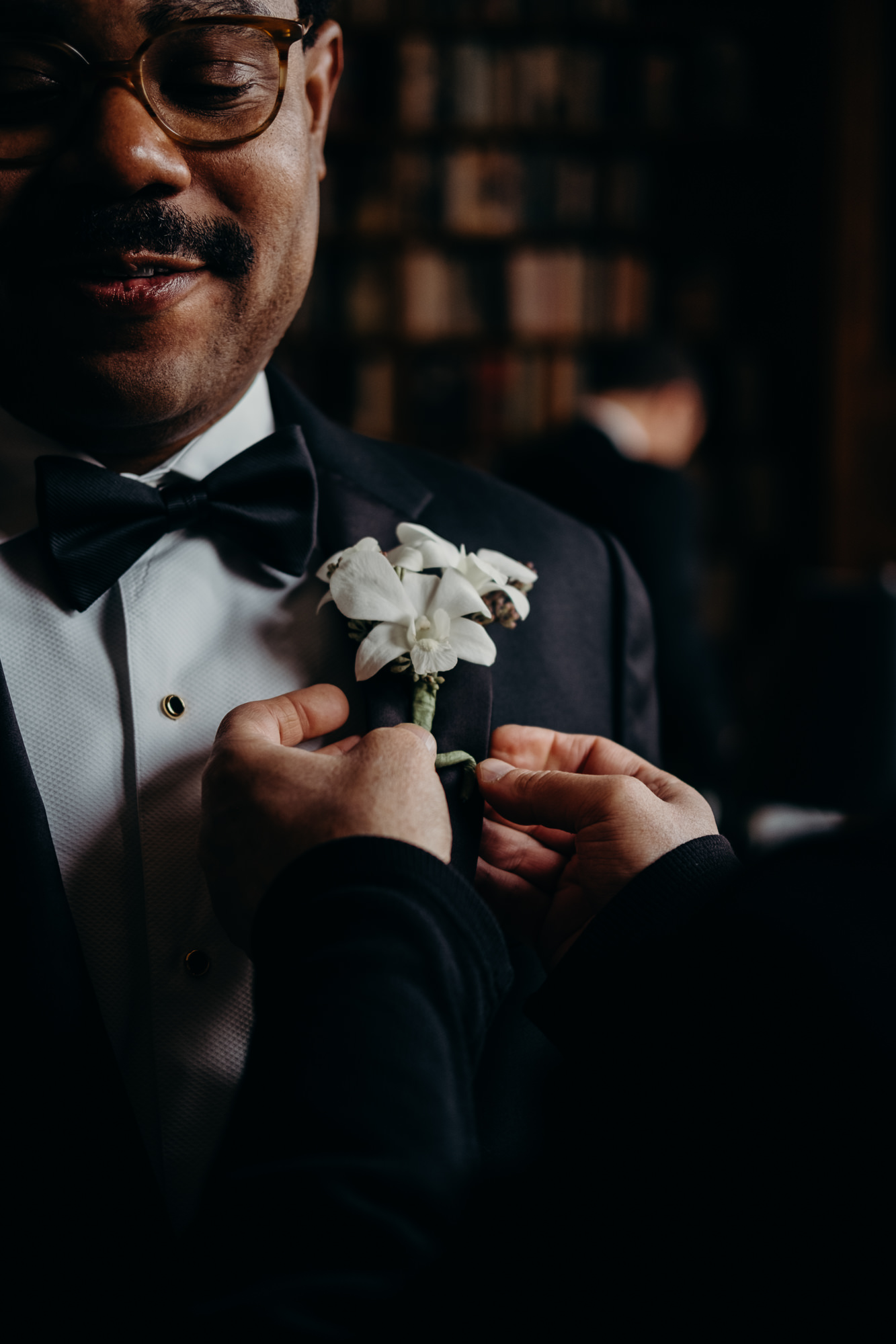 groom having boutonnier put on at cosmopolitan club in new york city, ny