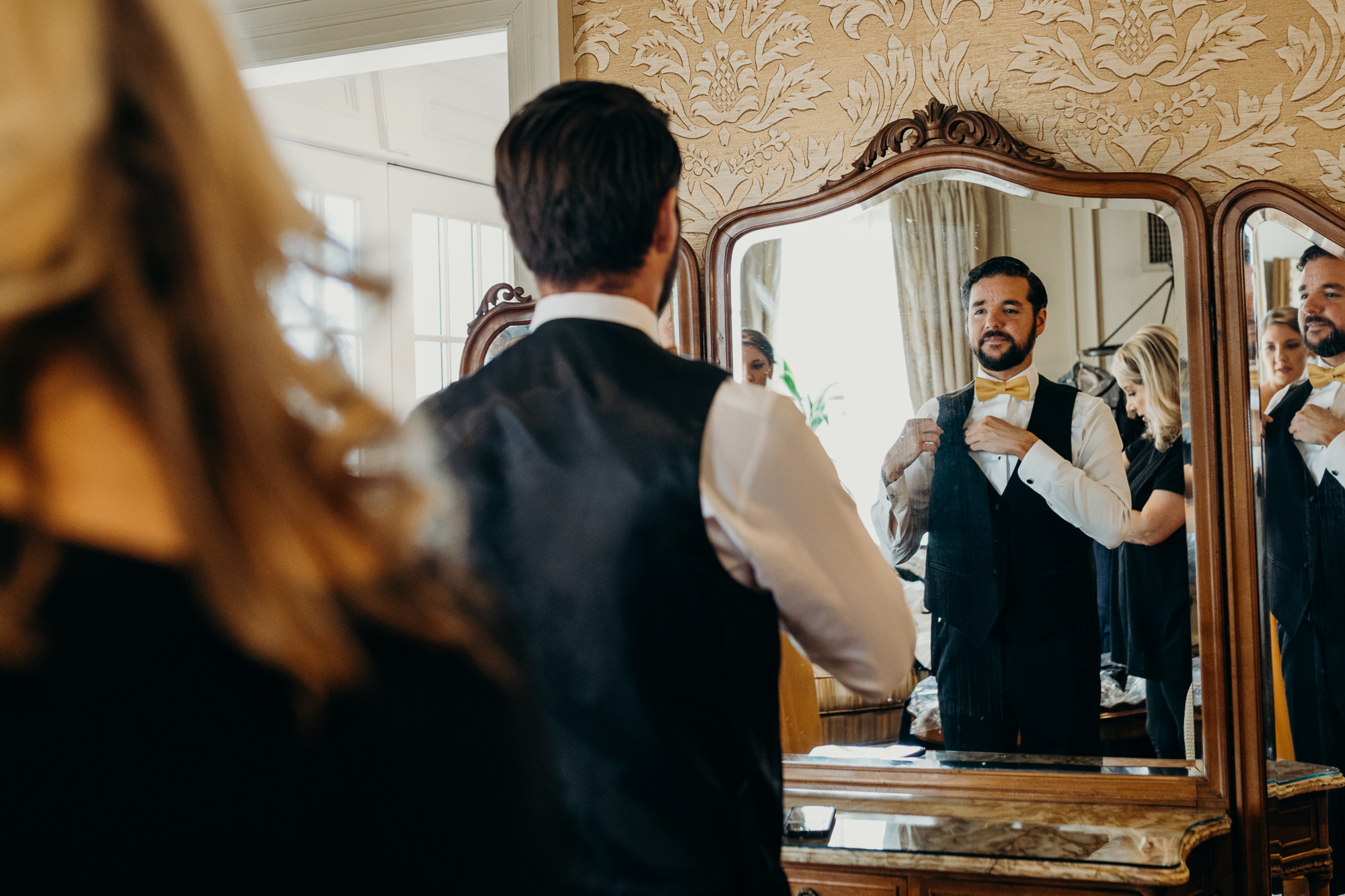 a bridesman getting ready for the wedding at the park savoy in florham park, new jersey