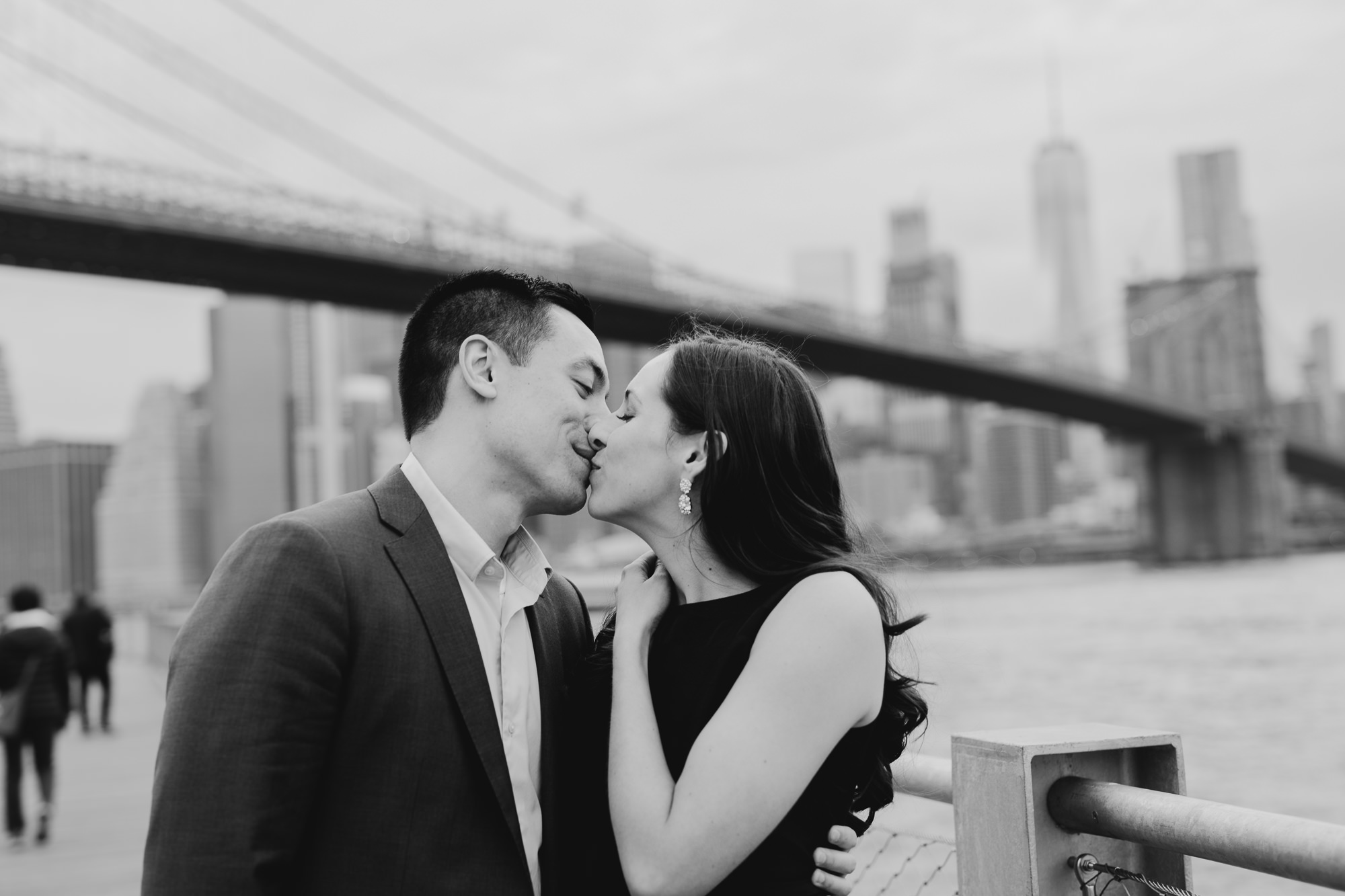 portrait of a couple kissing at brooklyn bridge park in brooklyn, new york