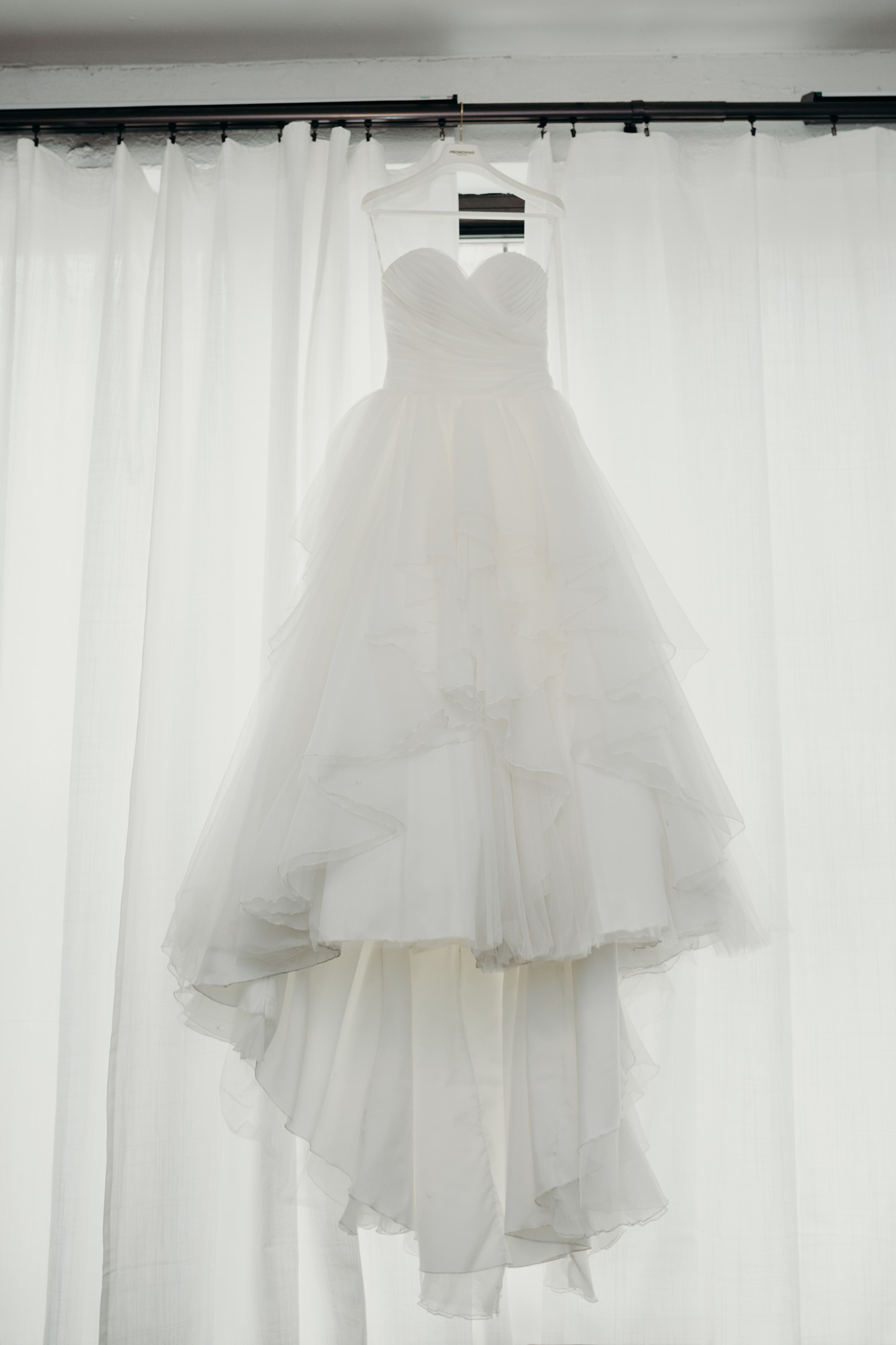 wedding gown hanging in the window at mymoon in brooklyn, new york