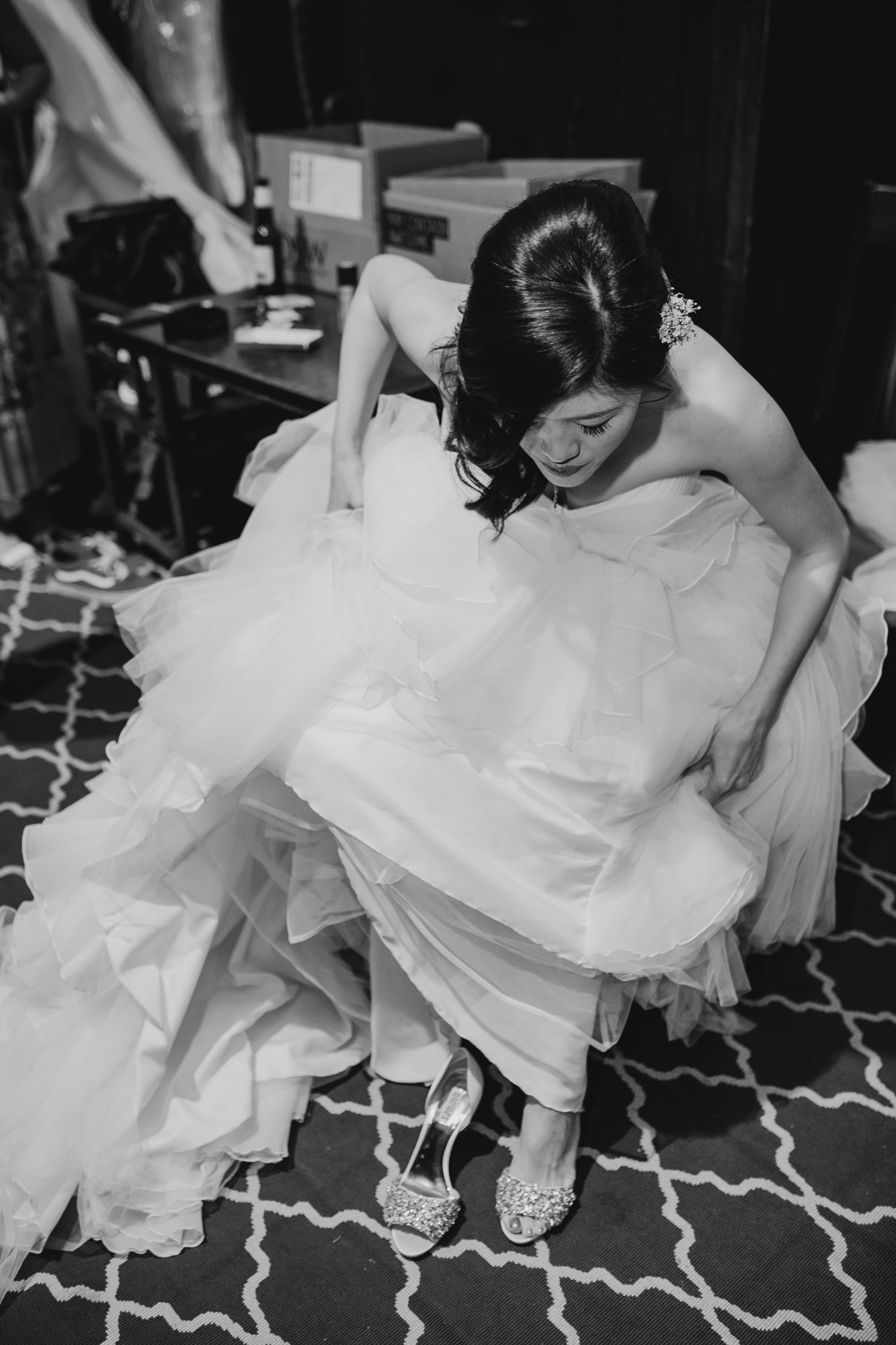 bride putting on her wedding shoes at mymoon in brooklyn, new york