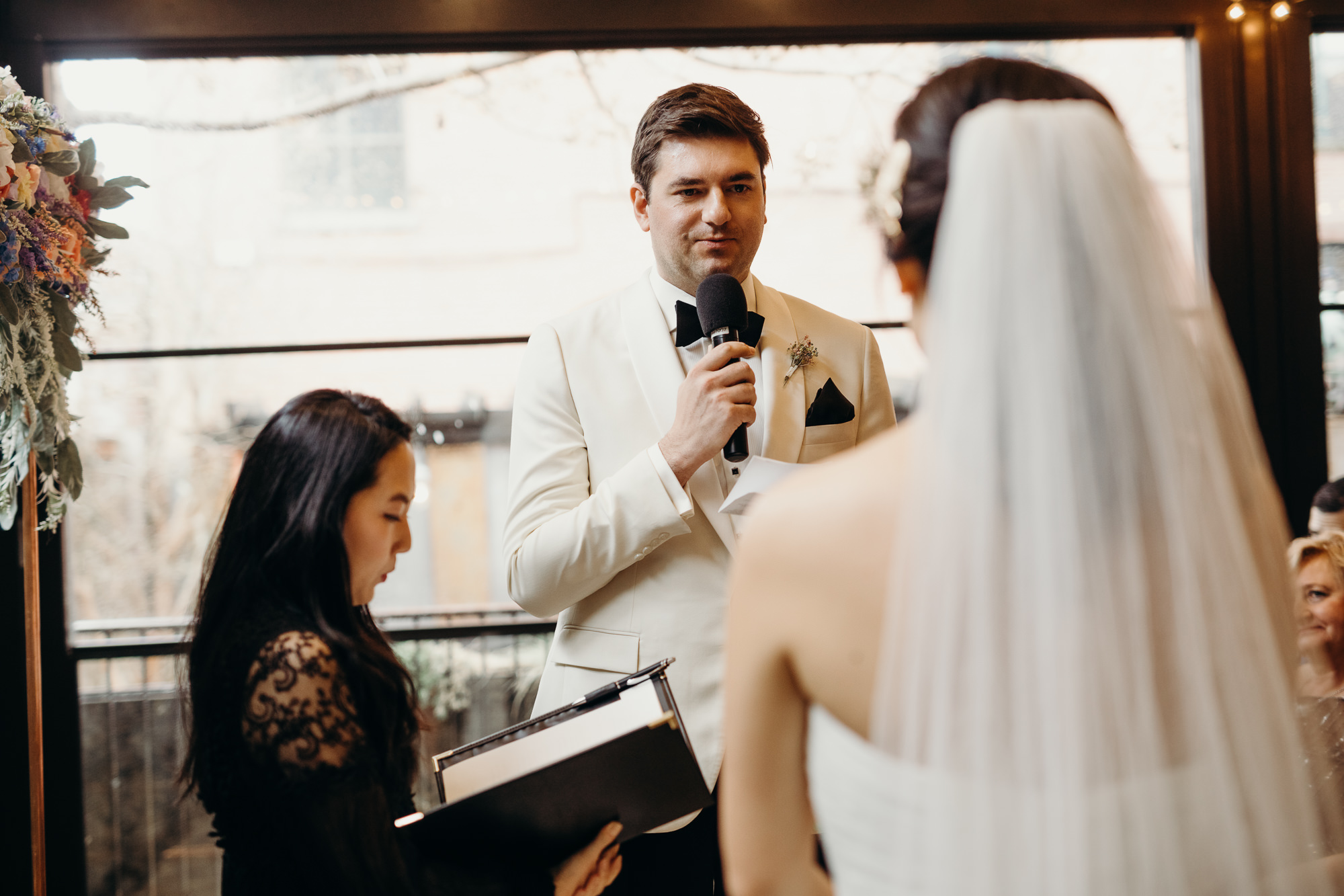 a groom recites his vows at mymoon in brooklyn, new york