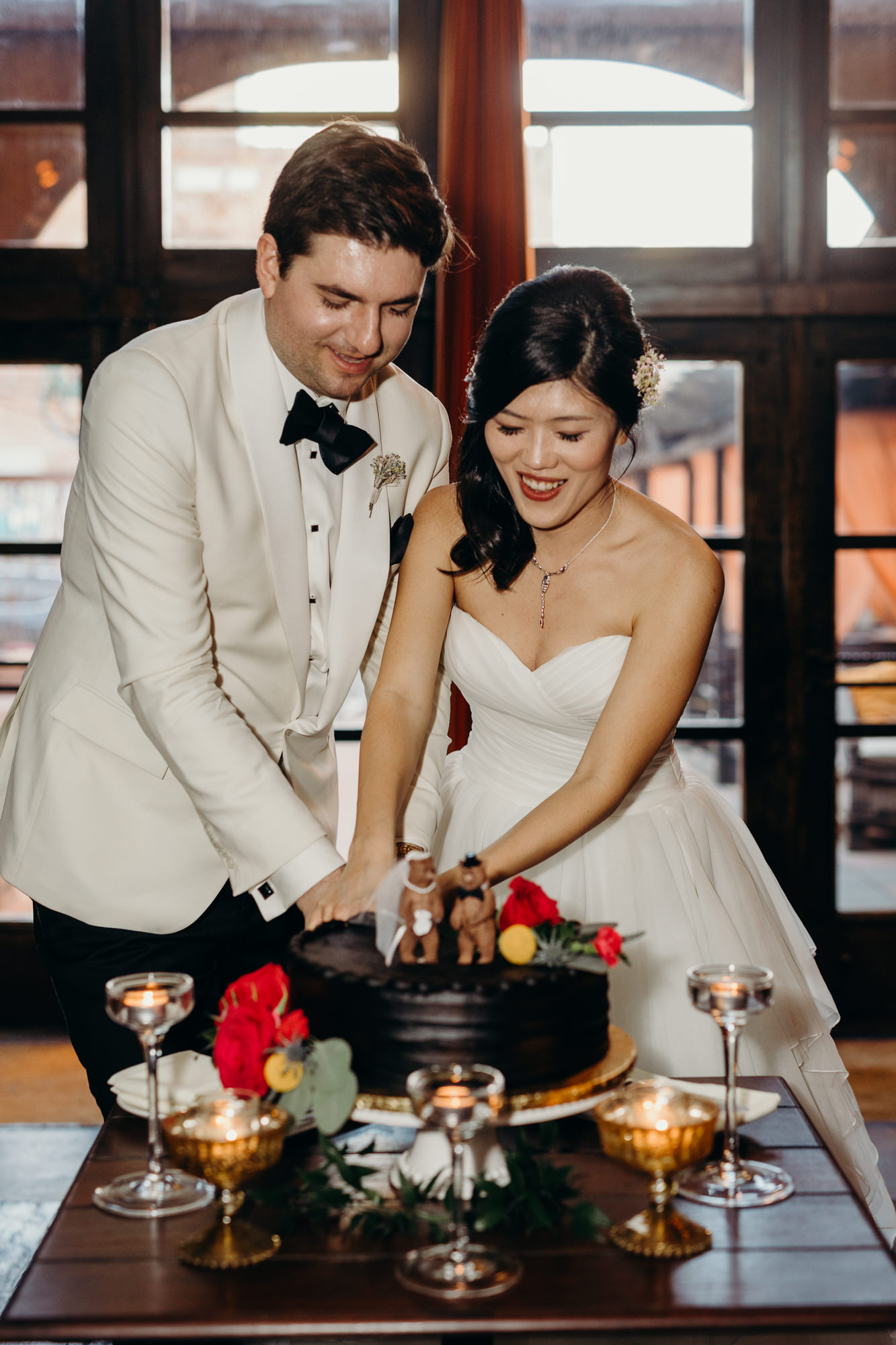 bride and groom cut their wedding cake at mymoon in brooklyn, new york
