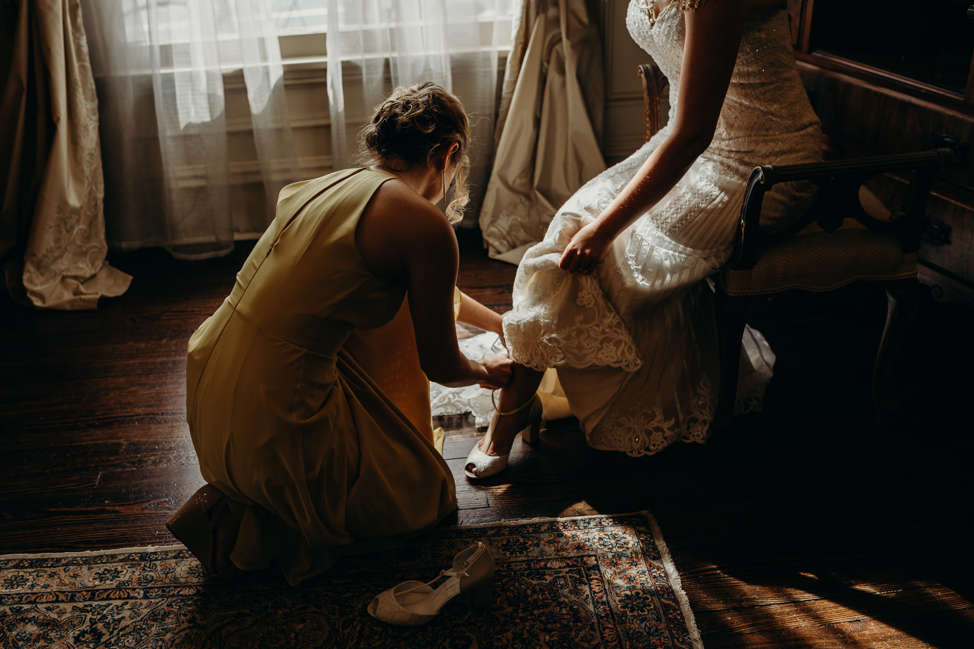 bride putting her shoes on at the park savoy in florham park, new jersey