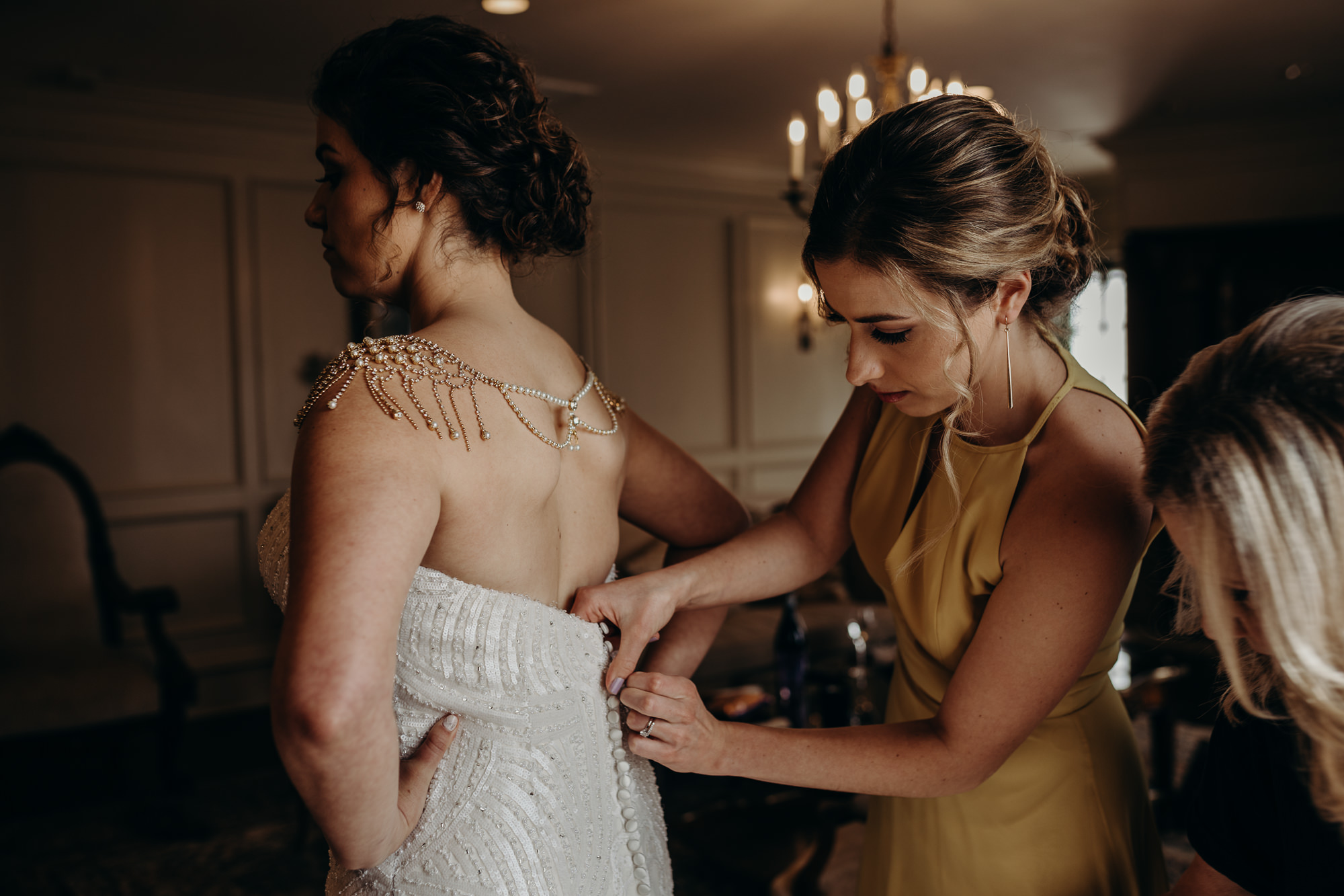 bride getting into her wedding dress at the park savoy in florham park, new jersey