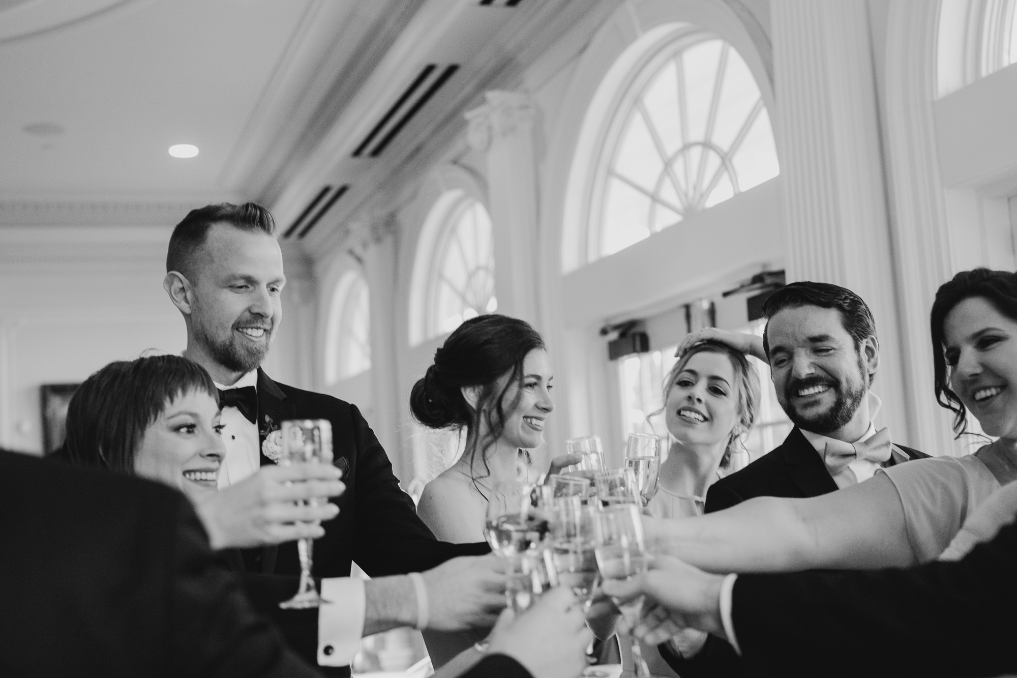 a wedding party cheers after the wedding ceremony at the park savoy in florham park, new jersey