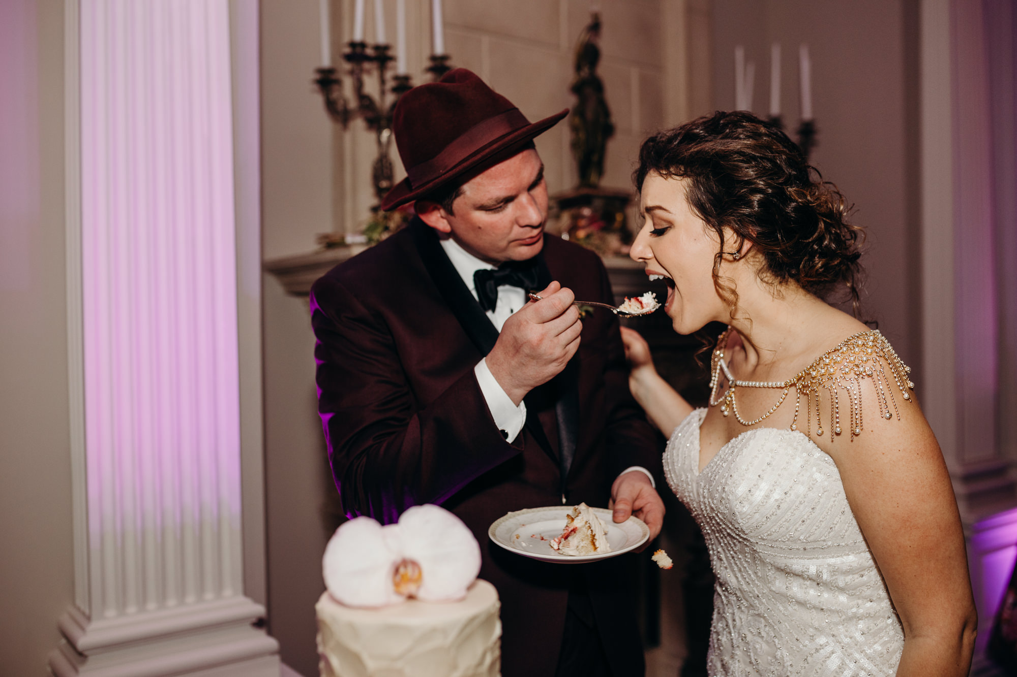 a bride and groom cut their wedding cake at the park savoy in florham park, new jersey