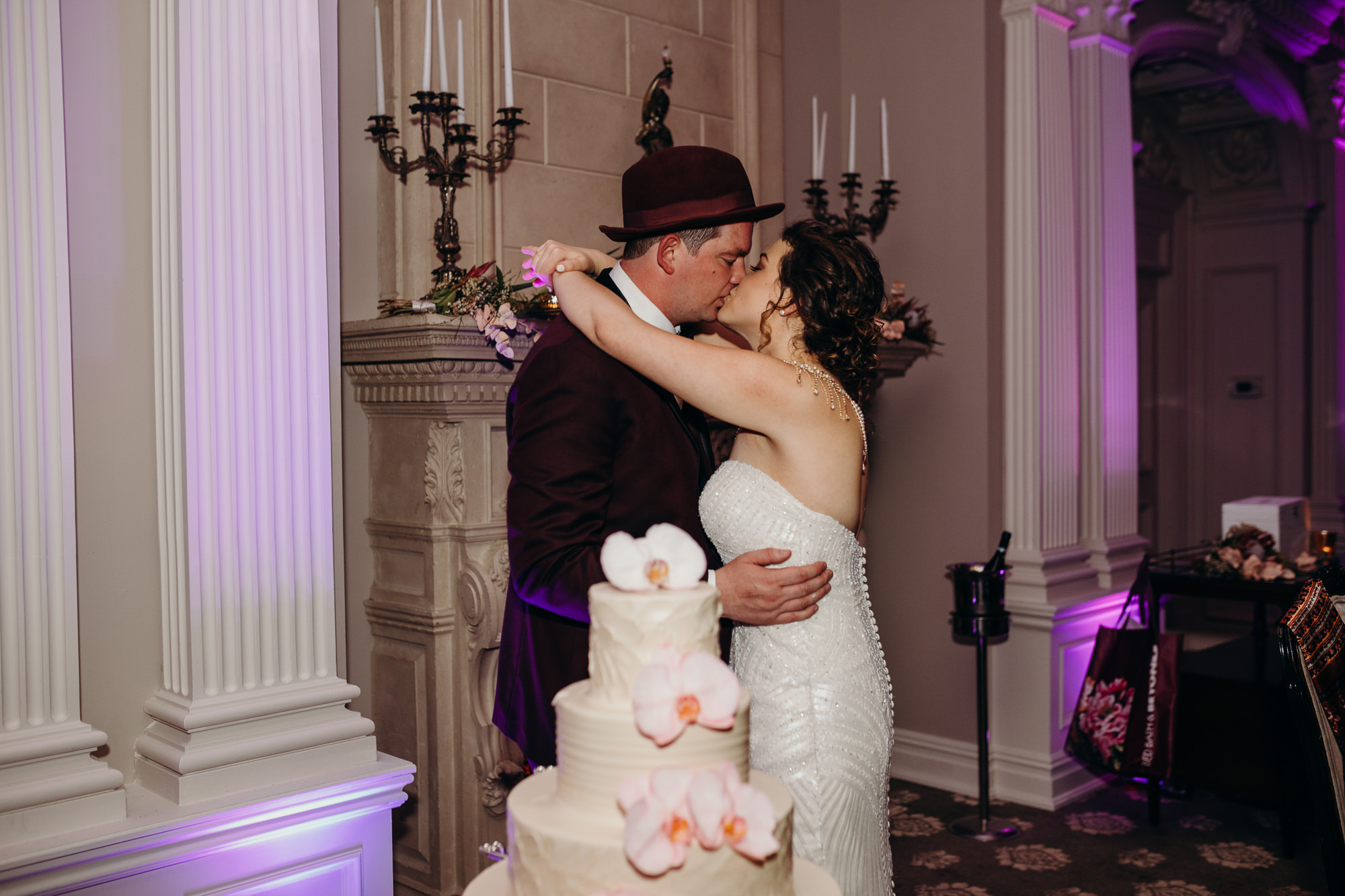 a bride and groom cut their wedding cake at the park savoy in florham park, new jersey