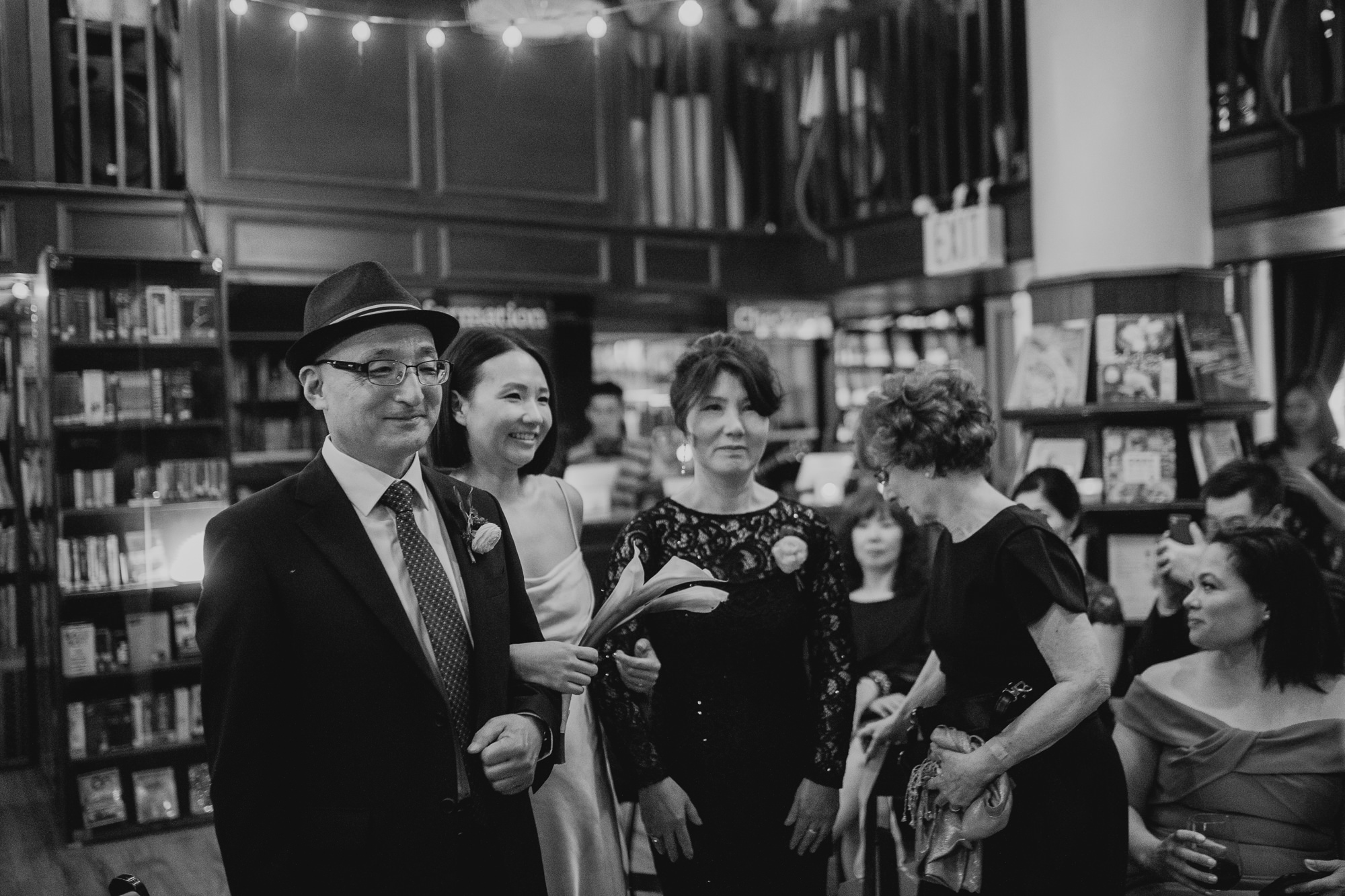bride with her parents during a wedding ceremony at housingworks bookstore in new york, new york