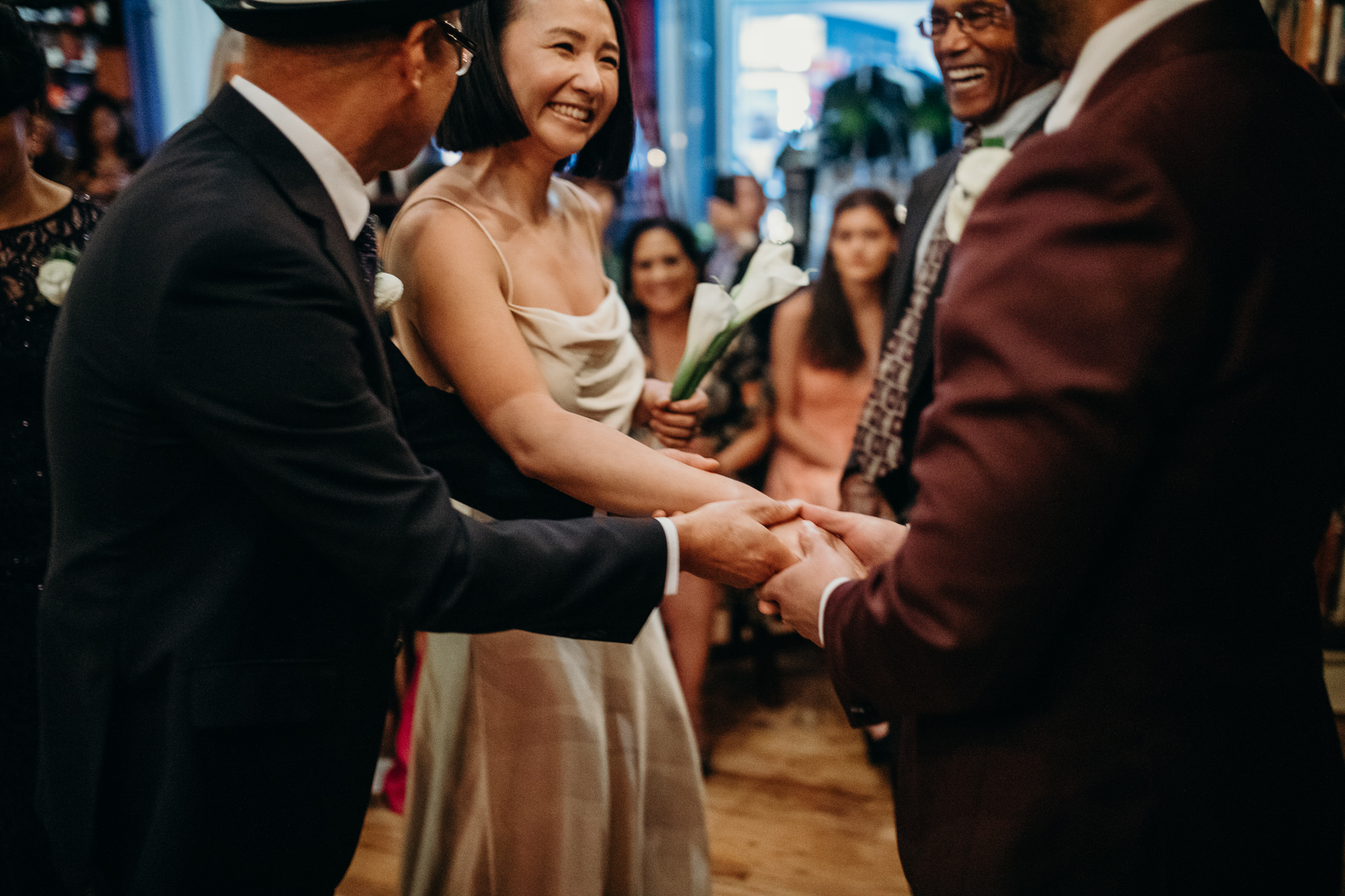 bride and groom during their wedding ceremony at housingworks bookstore in new york, new york