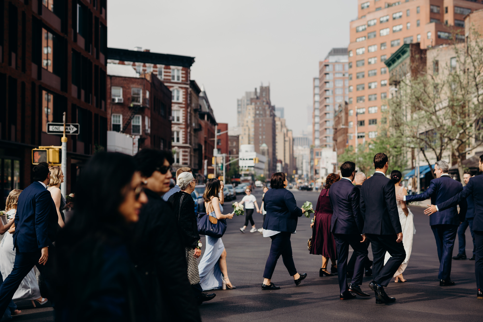 a wedding party walks through the west village, new york city