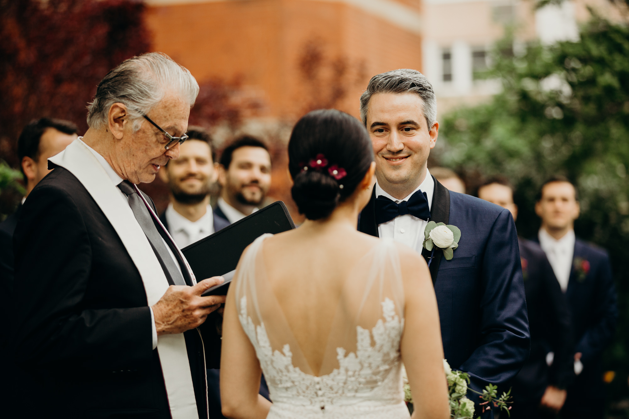 a portrait of a groom during a wedding ceremony at jefferson market garden in the west village, new york city