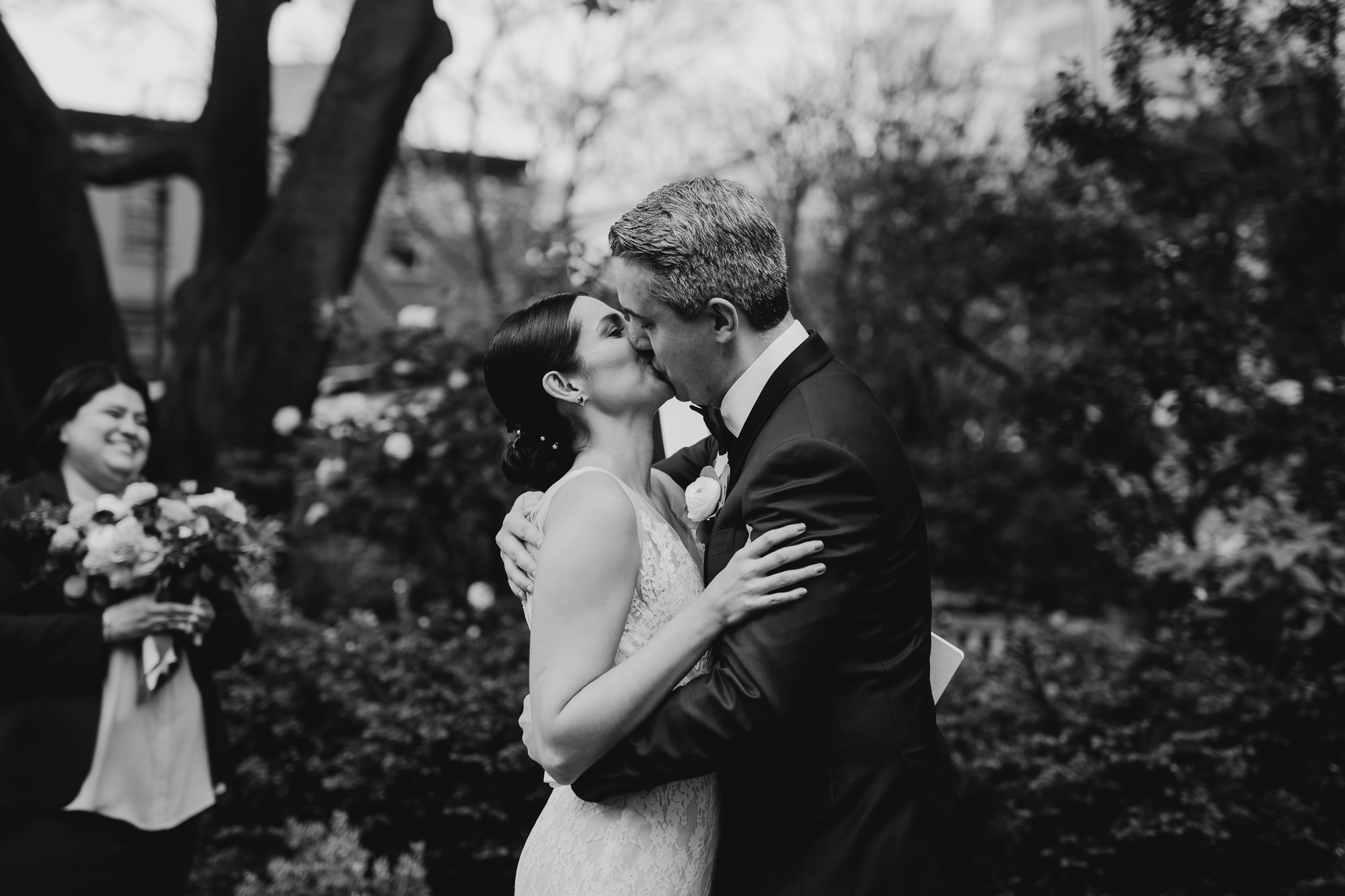 a bride and groom kiss at jefferson market garden in the west village, new york city