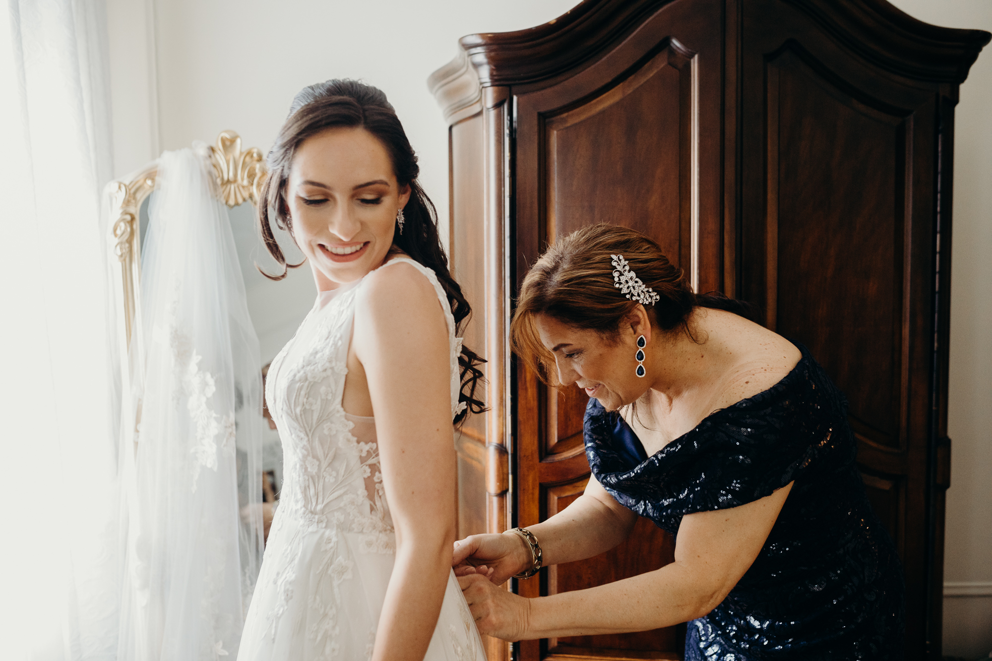a bride getting into her wedding gown at liberty warehouse in brooklyn, new york city