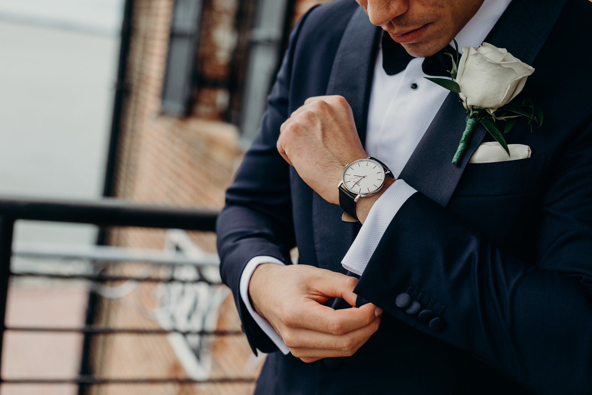 a groom getting ready for his wedding at liberty warehouse in brooklyn, new york city